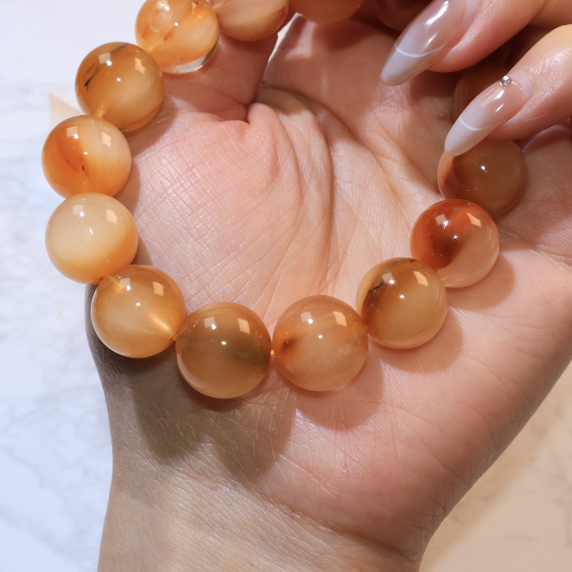 Warm-toned Yellow Rabbit Hair Quartz beads in close-up showing transparency, silky texture, and brown misty patterns