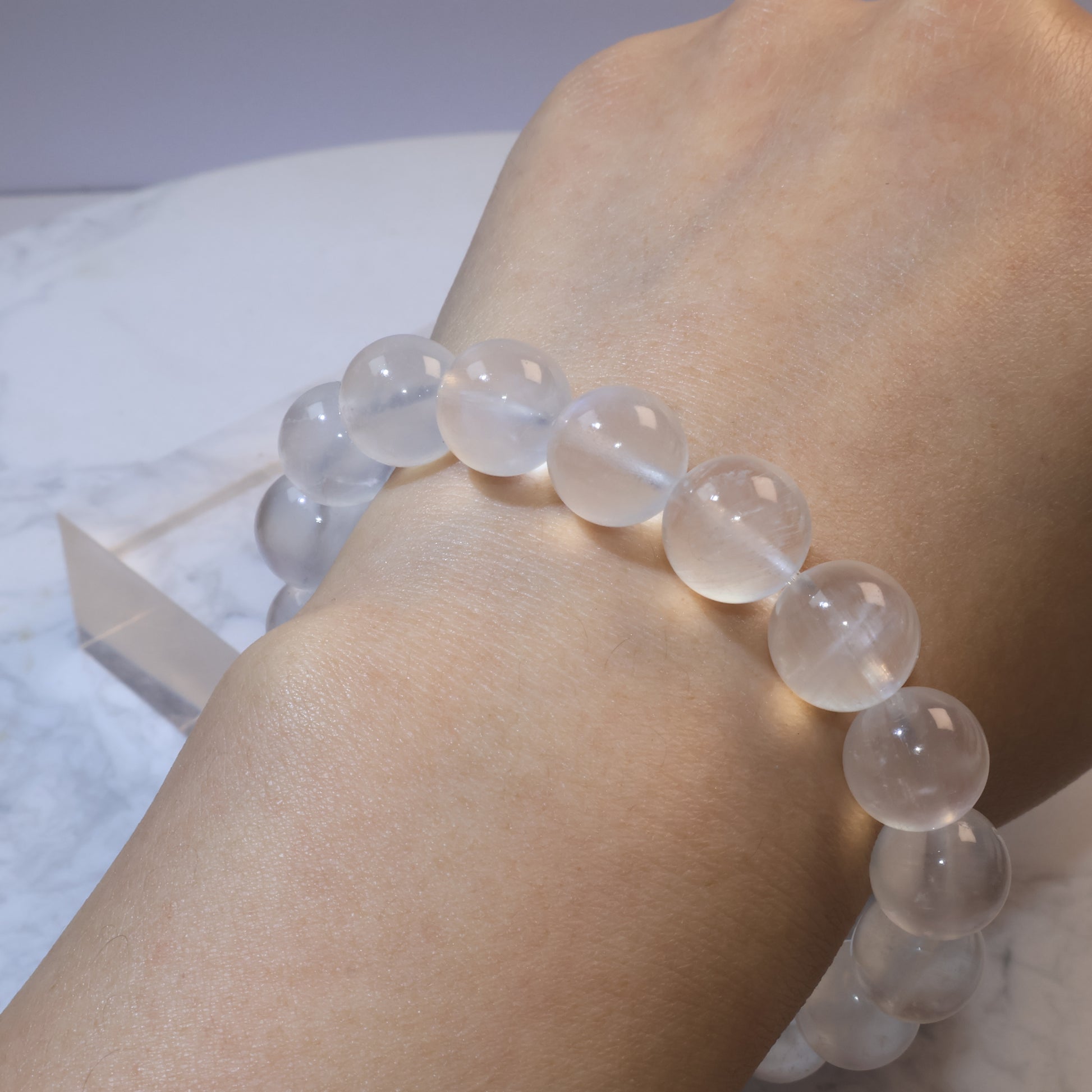 Wrist shot wearing moonstone bracelet, soft glow against skin