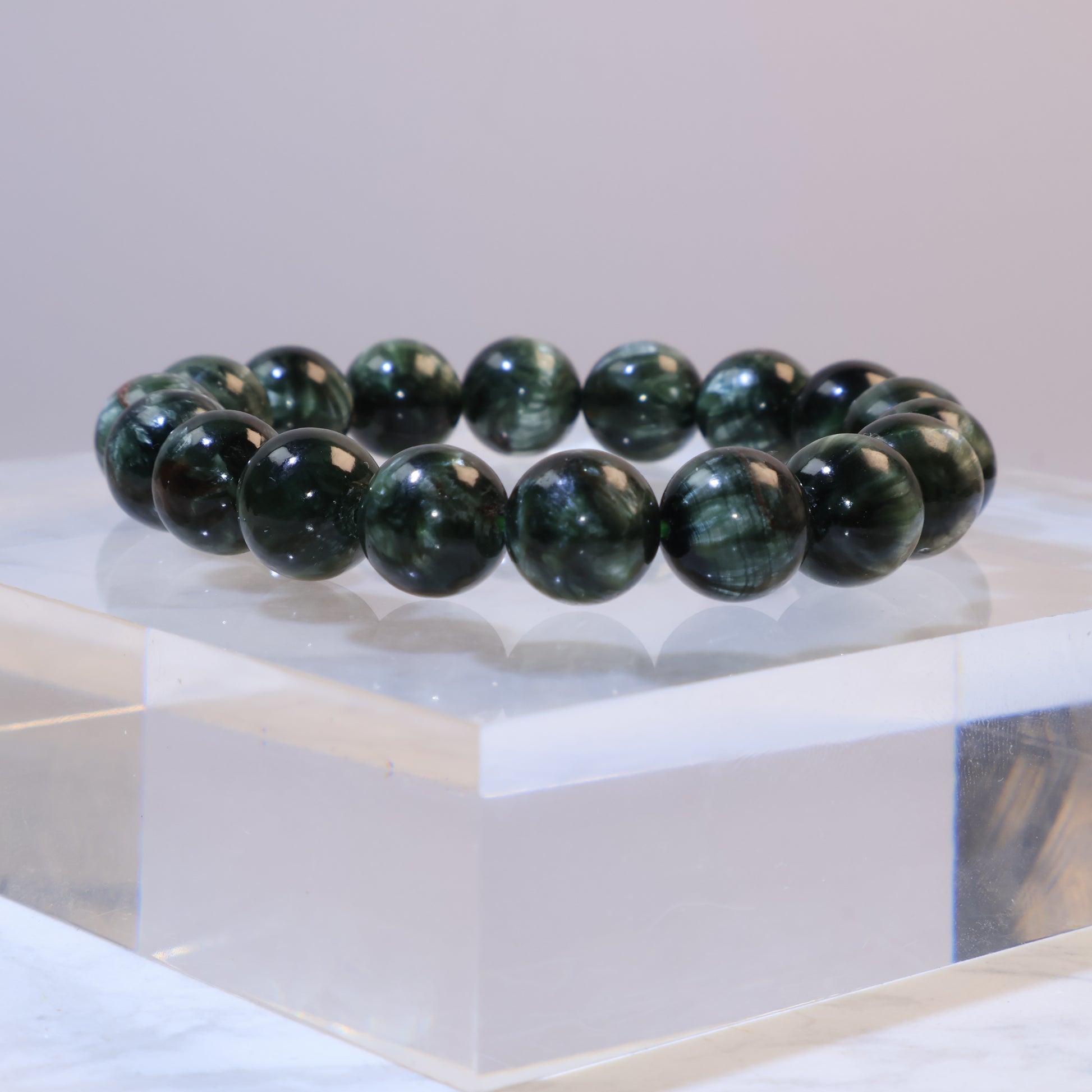 Seraphinite bracelet 11mm Russia – side display on acrylic block