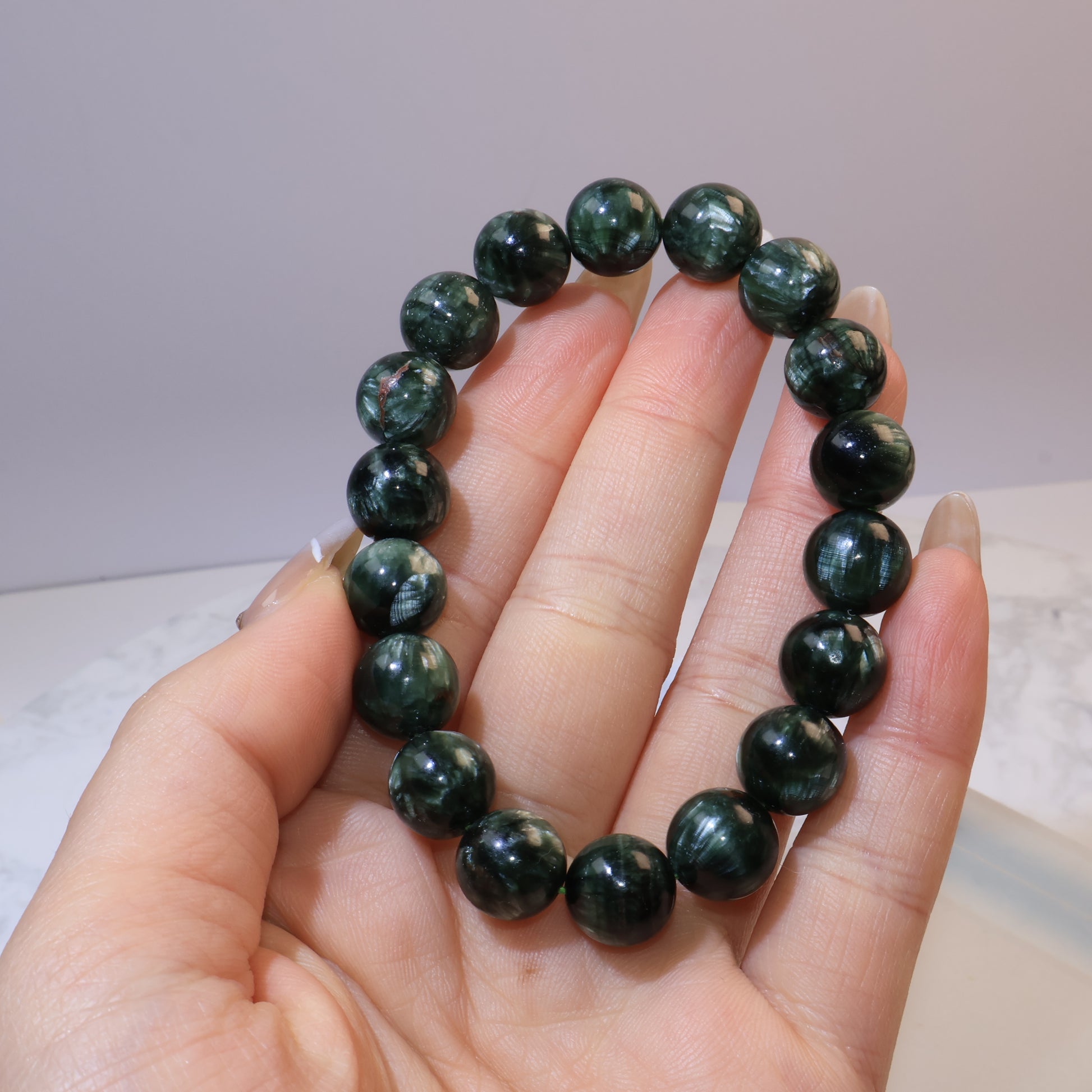 Seraphinite bracelet 11mm Russia – held in hand