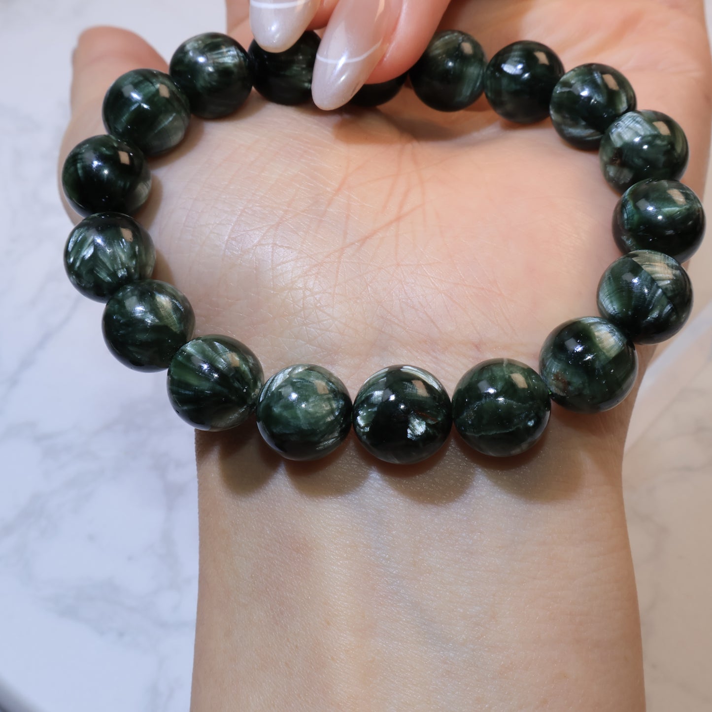 Seraphinite bracelet 11mm Russia – close-up on wrist front view