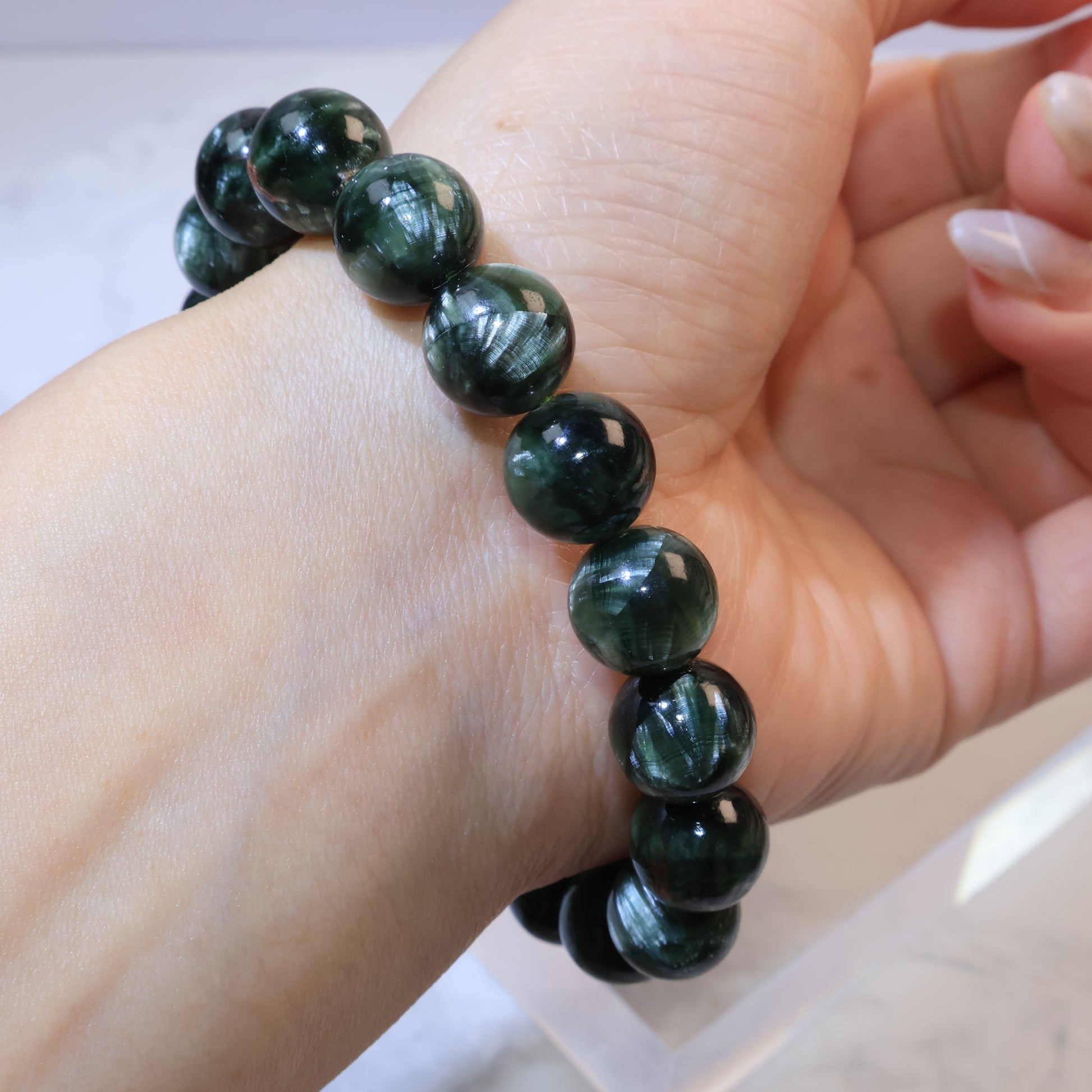 Seraphinite bracelet 11mm Russia – worn on wrist angled view