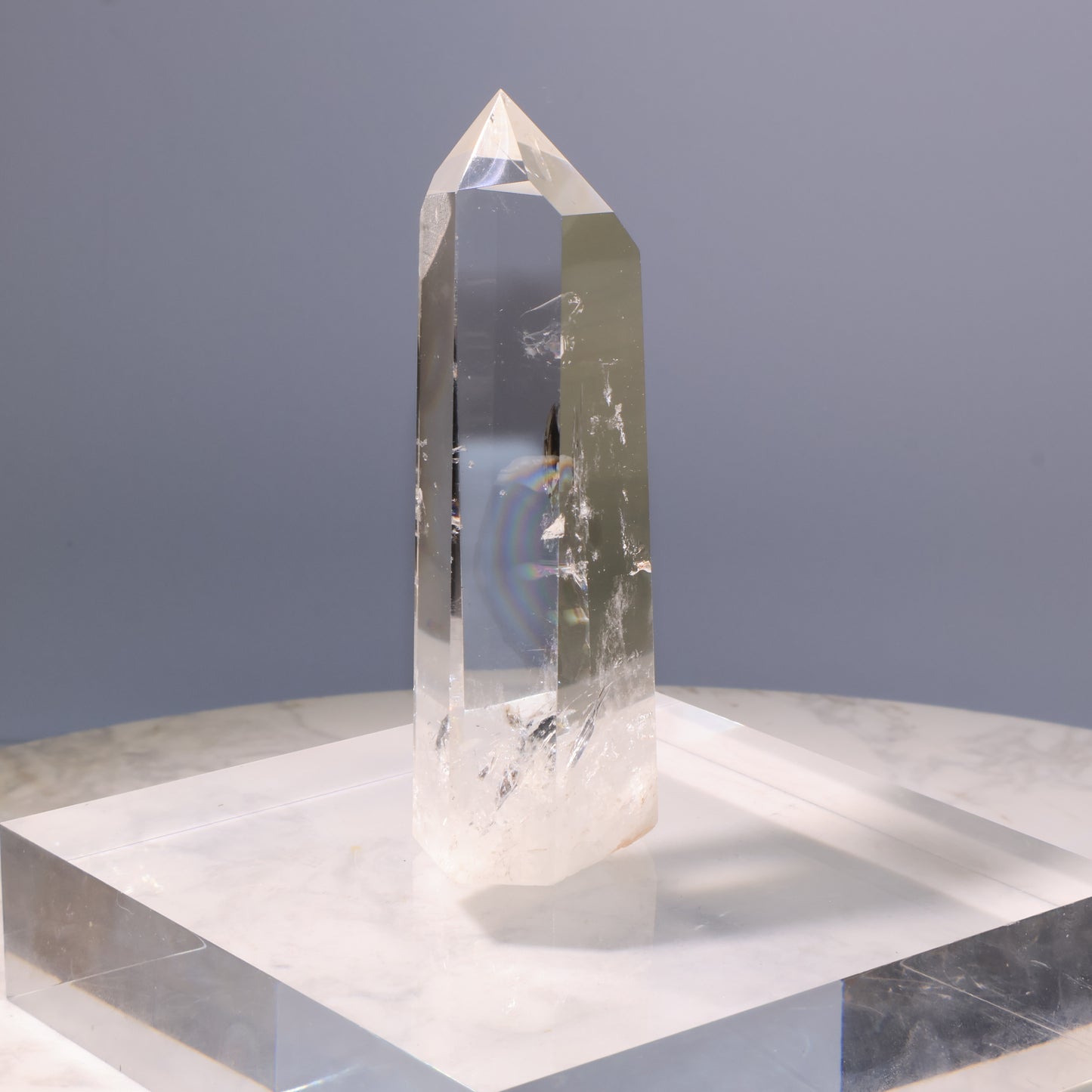 Clear Quartz Tower – angled view with rainbow reflection inside crystal.