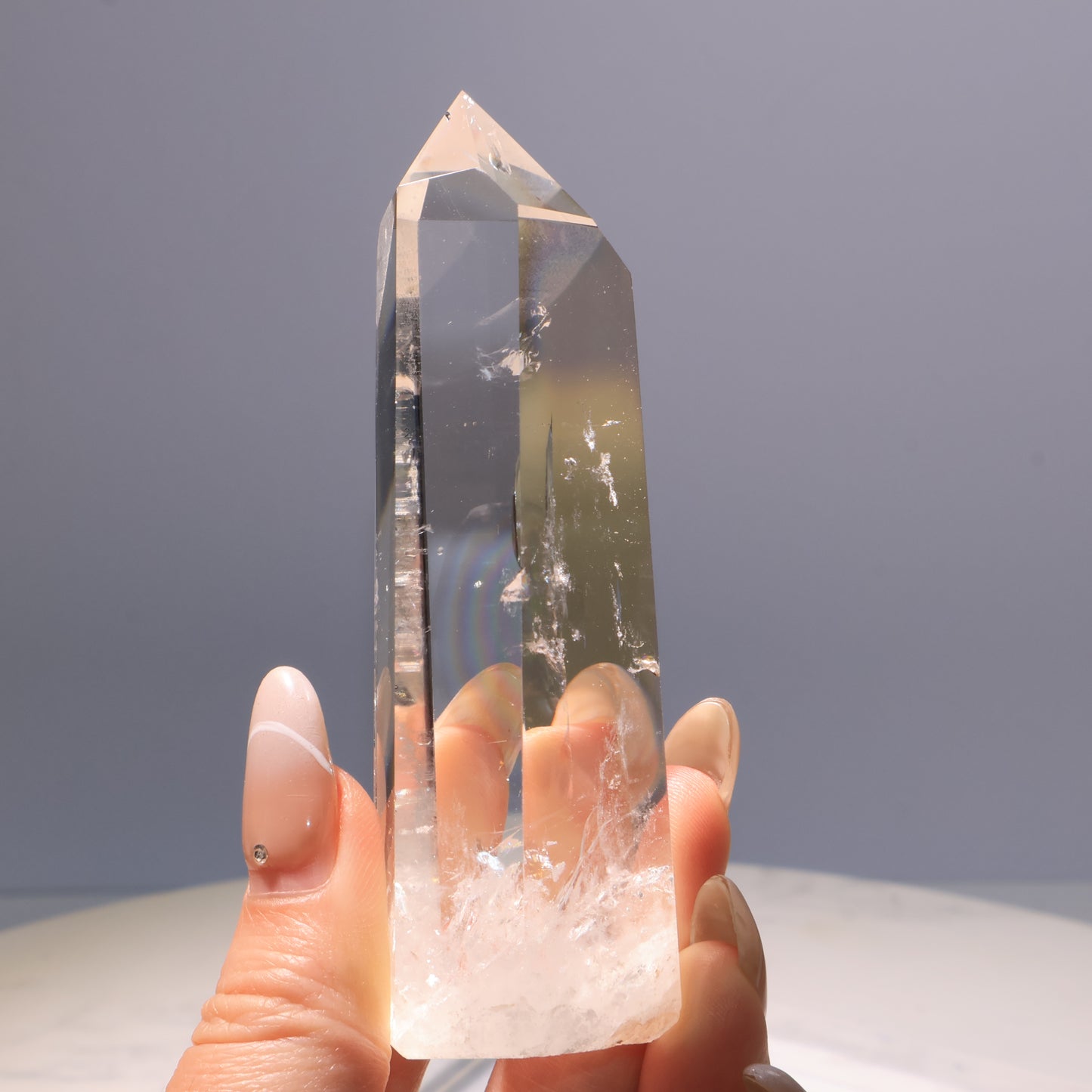 Clear Quartz Tower – handheld display highlighting transparency and rainbows.