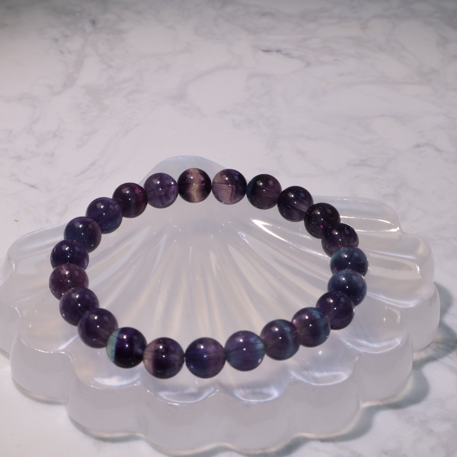 Natural fluorite bracelet with clear banding patterns shown from above.