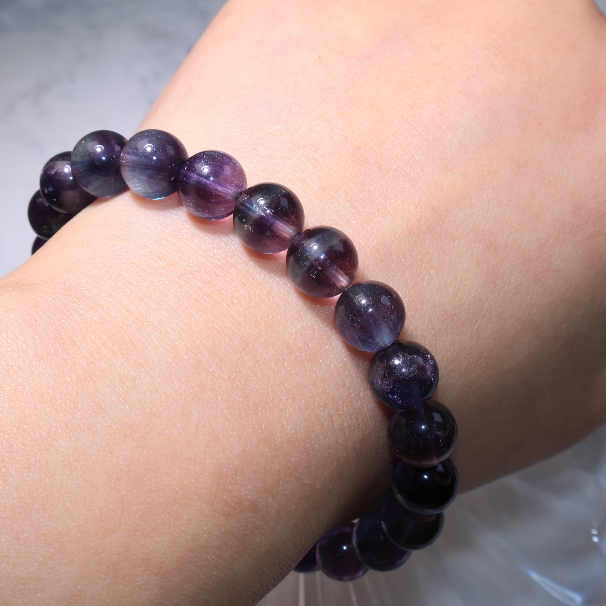 Fluorite bracelet worn on wrist, highlighting natural luster and color variation.