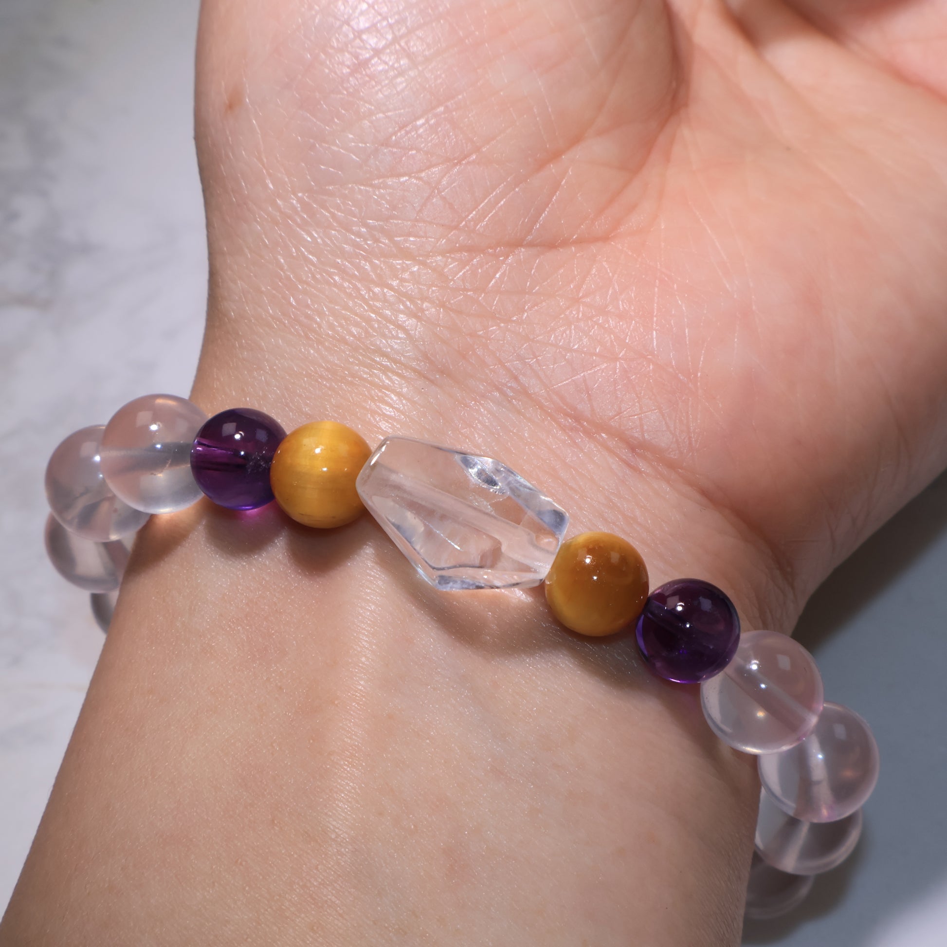 Another wrist angle displaying the freeform Clear Quartz and gemstone arrangement.