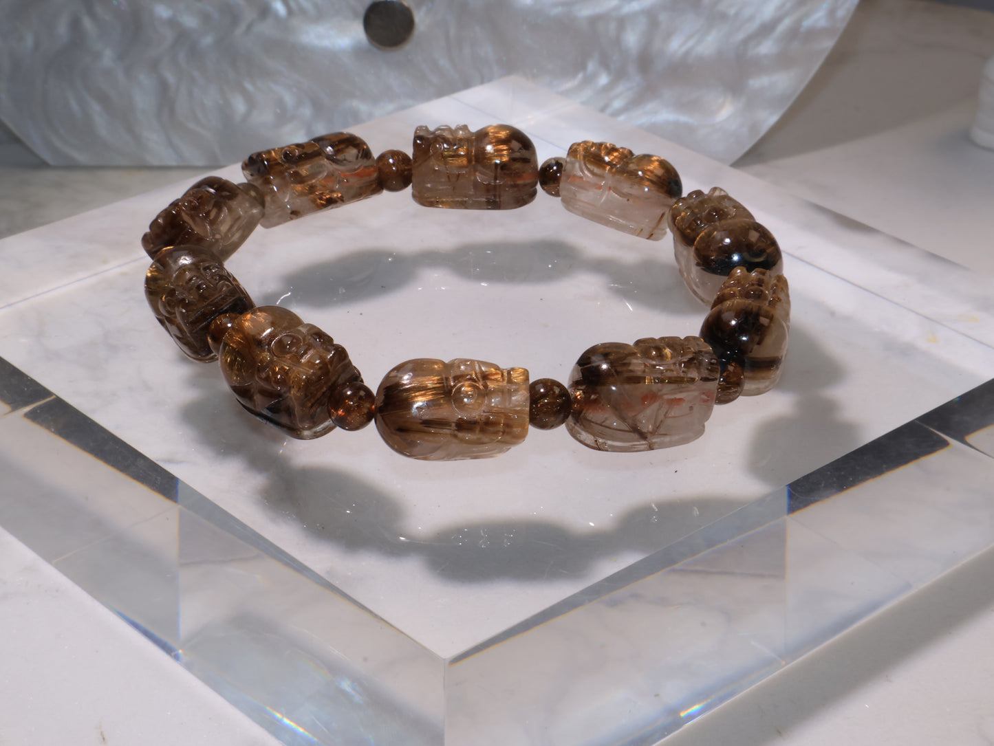 Close-up of the bracelet emphasizing the detailed carving and warm golden tones.