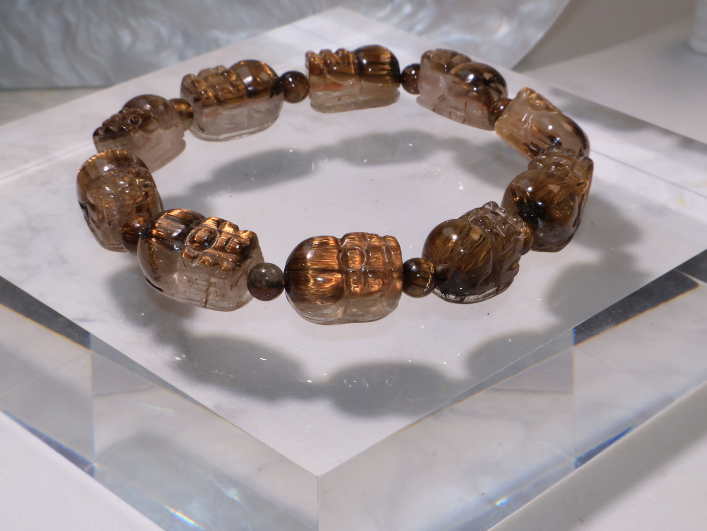 Side view of the Pixiu bracelet highlighting the lustrous rutile inclusions within each bead.