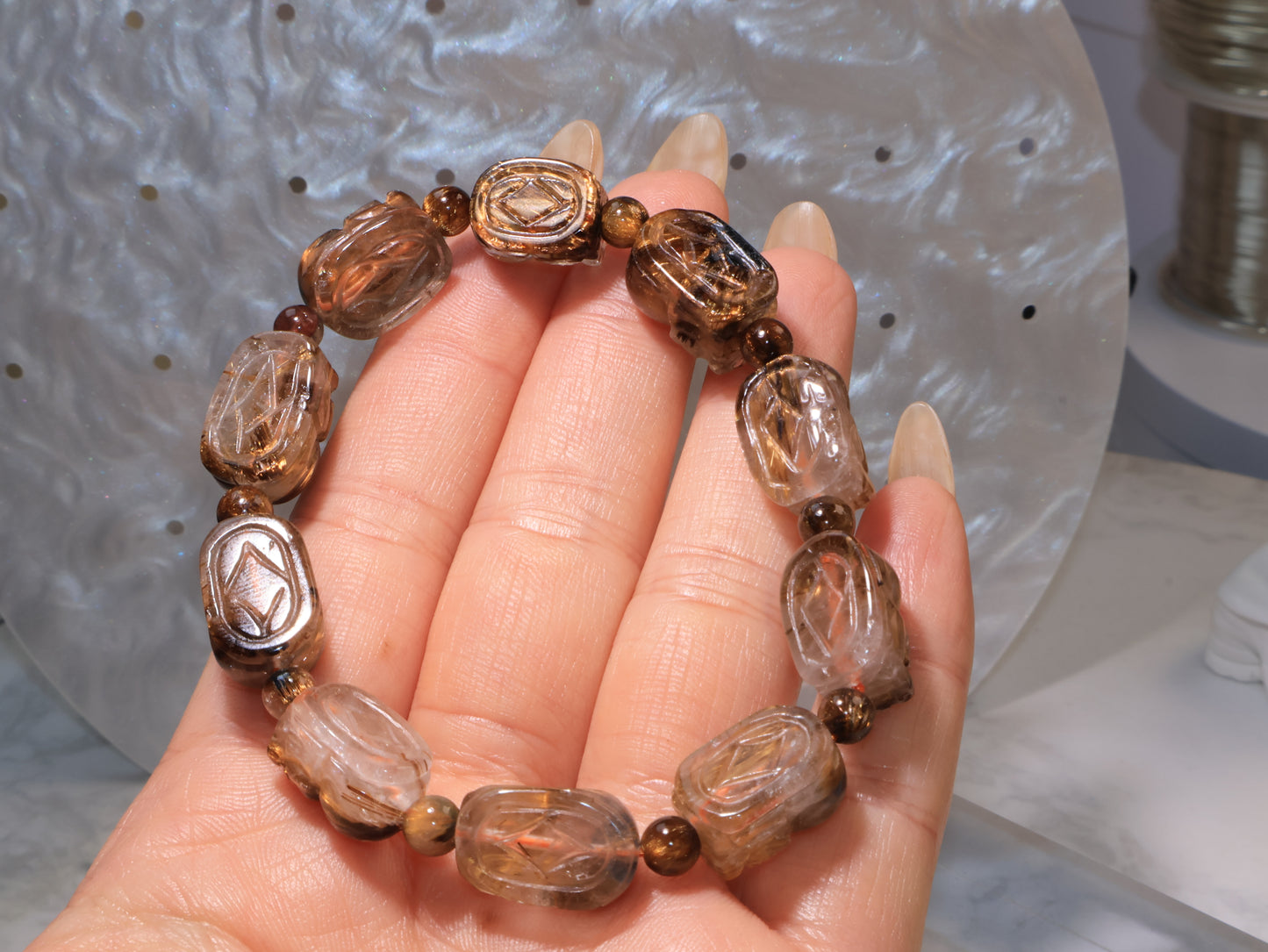 Reverse side of the bracelet showing the back carving details of each Pixiu bead.
