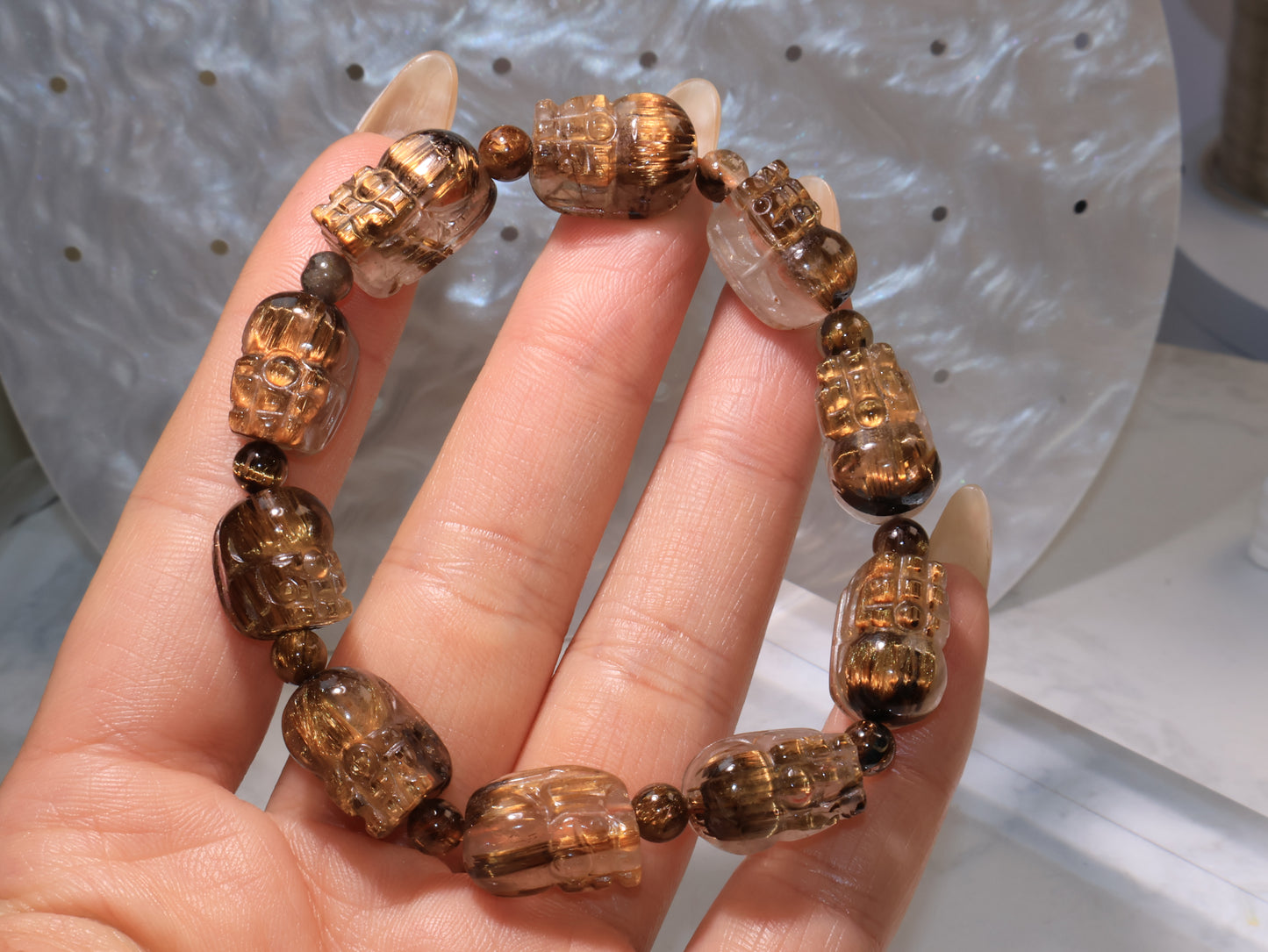 Bracelet displayed on fingers, revealing each carved Pixiu’s facial and body details.