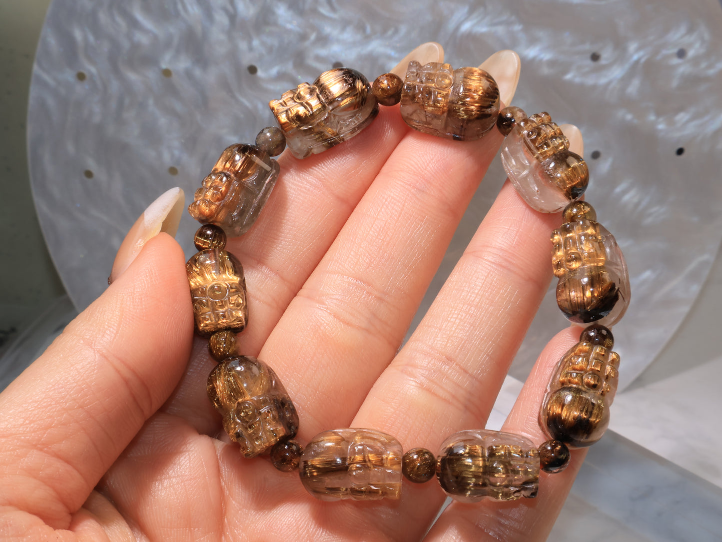 Hand-holding view showing the bracelet’s natural transparency and texture.