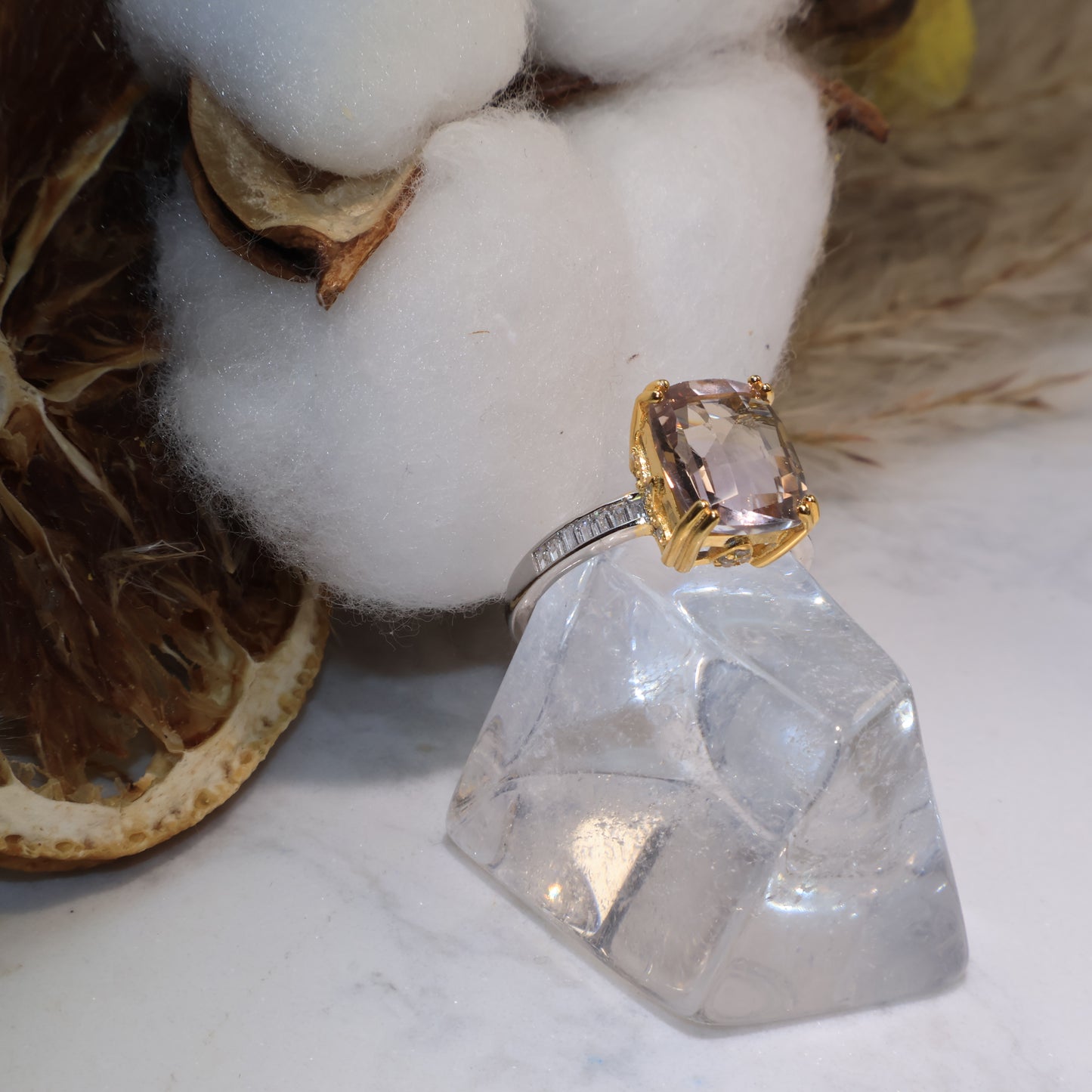 Side view of the ametrine ring showing its cushion-cut shape and gold-prong setting.