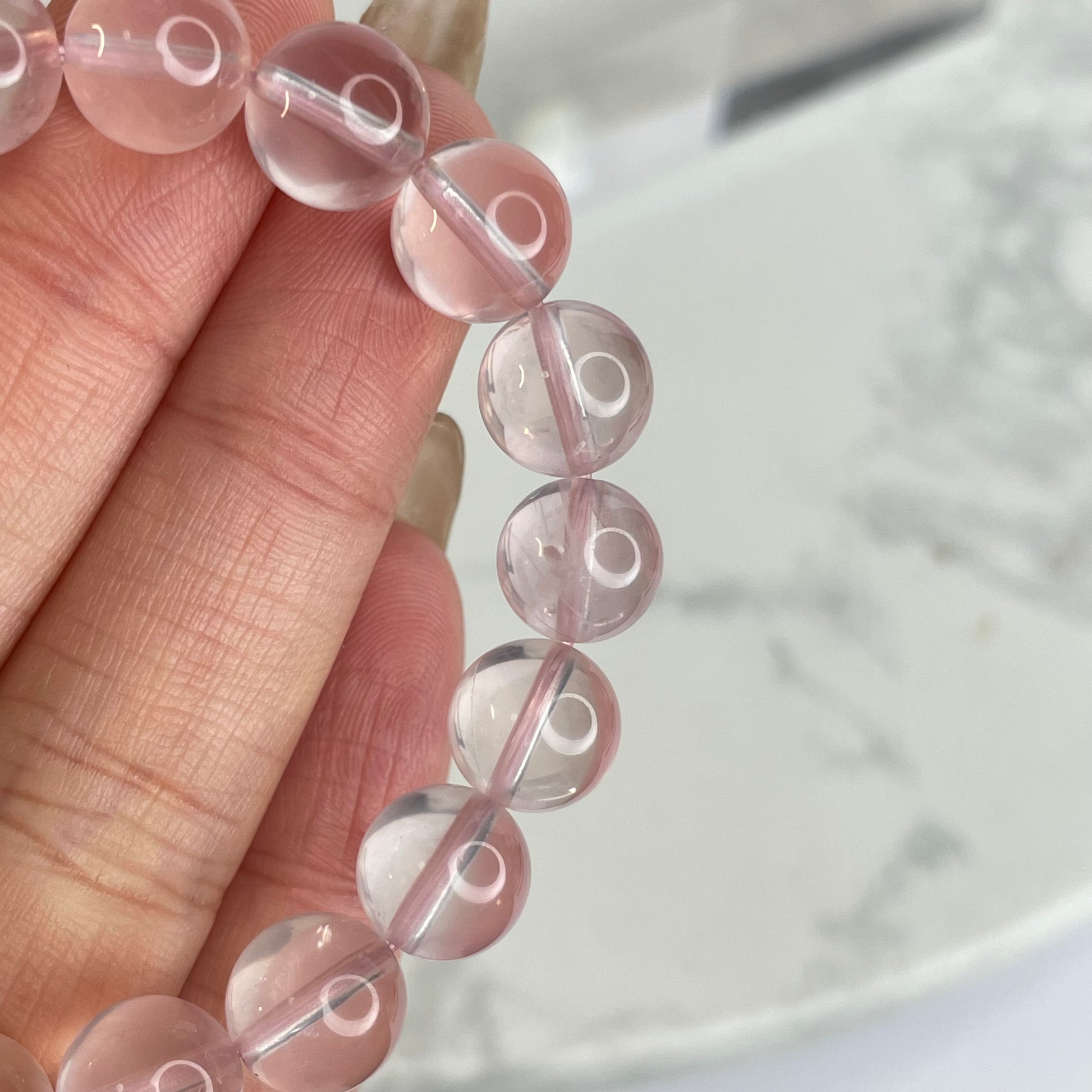 Rose Quartz bracelet close view highlighting transparent and luminous 8mm beads