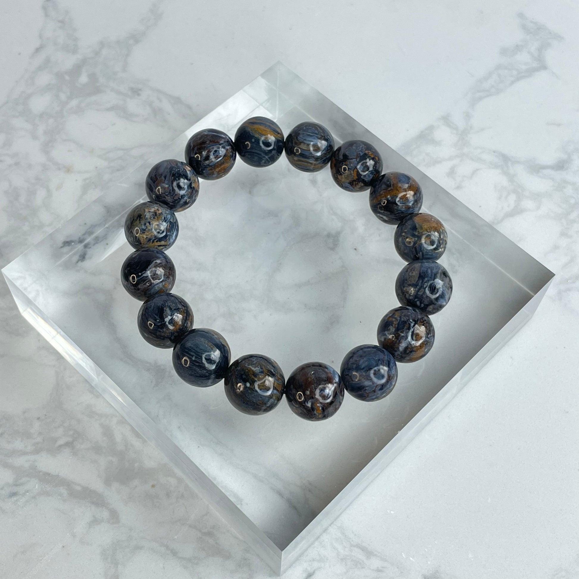 Power Core 13mm Pietersite crystal bracelet – dark swirling beads from Namibia with golden and blue chatoyancy, enhancing strength and inner clarity.
