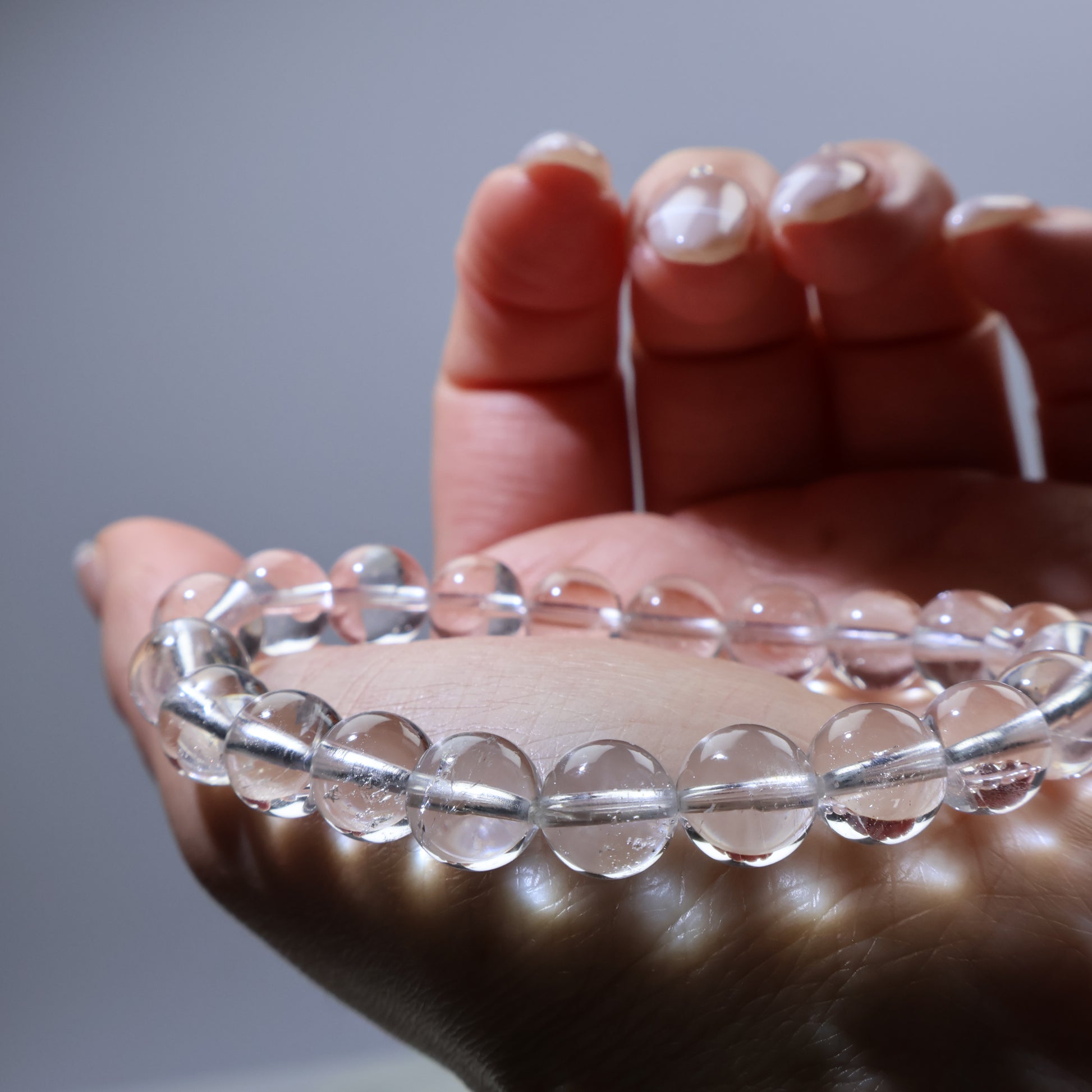 Light-reflecting quartz beads on hand – daily wear energy bracelet
