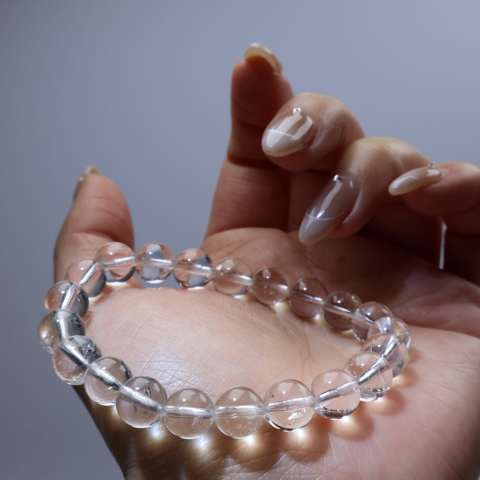 Natural clear quartz bracelet gently held – spiritual and minimalist