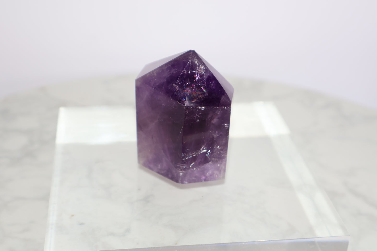 Front close-up of Royal Amethyst Tower No.01 – 98g Brazilian Crystal with rainbow inclusion and clear facets