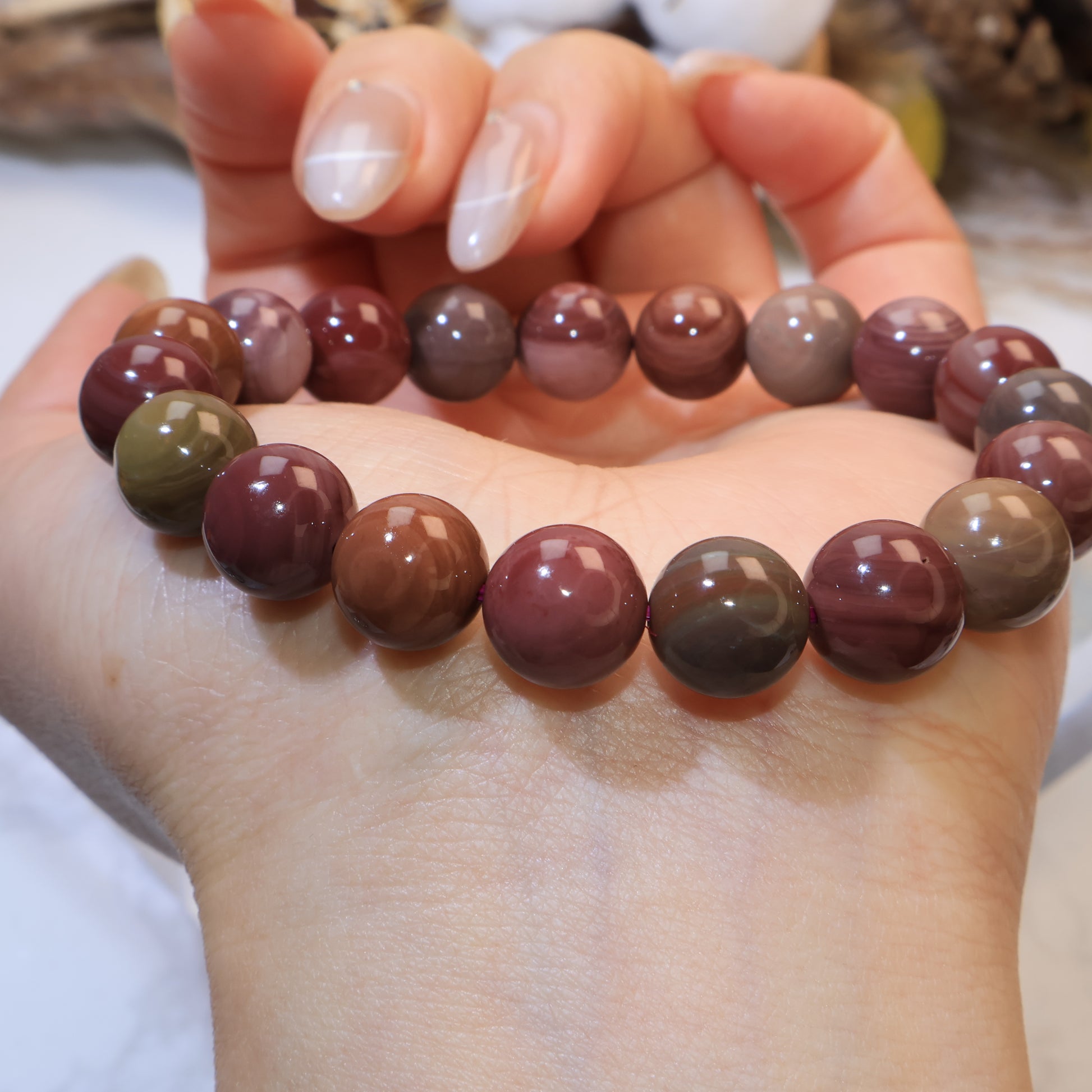 Close-up wrist shot showing detailed patterns of Mookaite Jasper beads