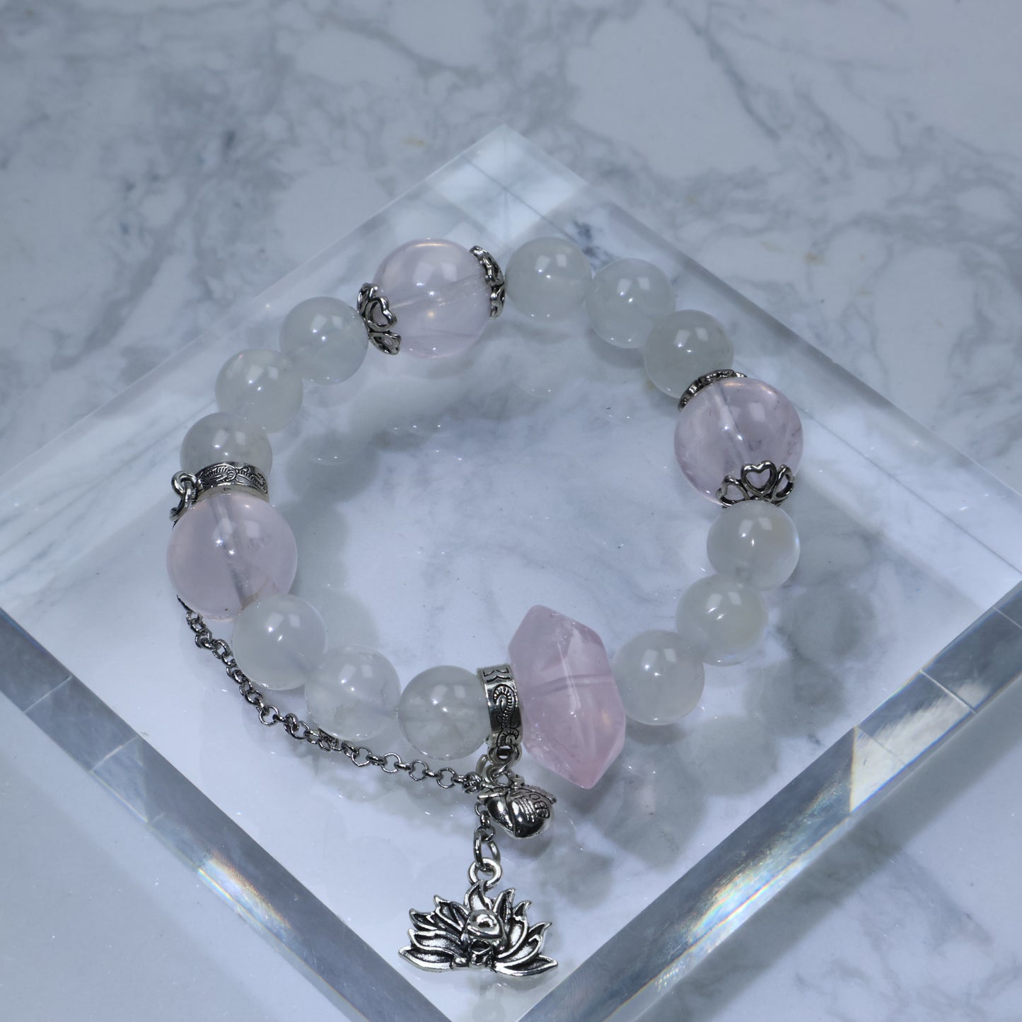 Flat lay of Mystic Key original bracelet with 福 peach charm