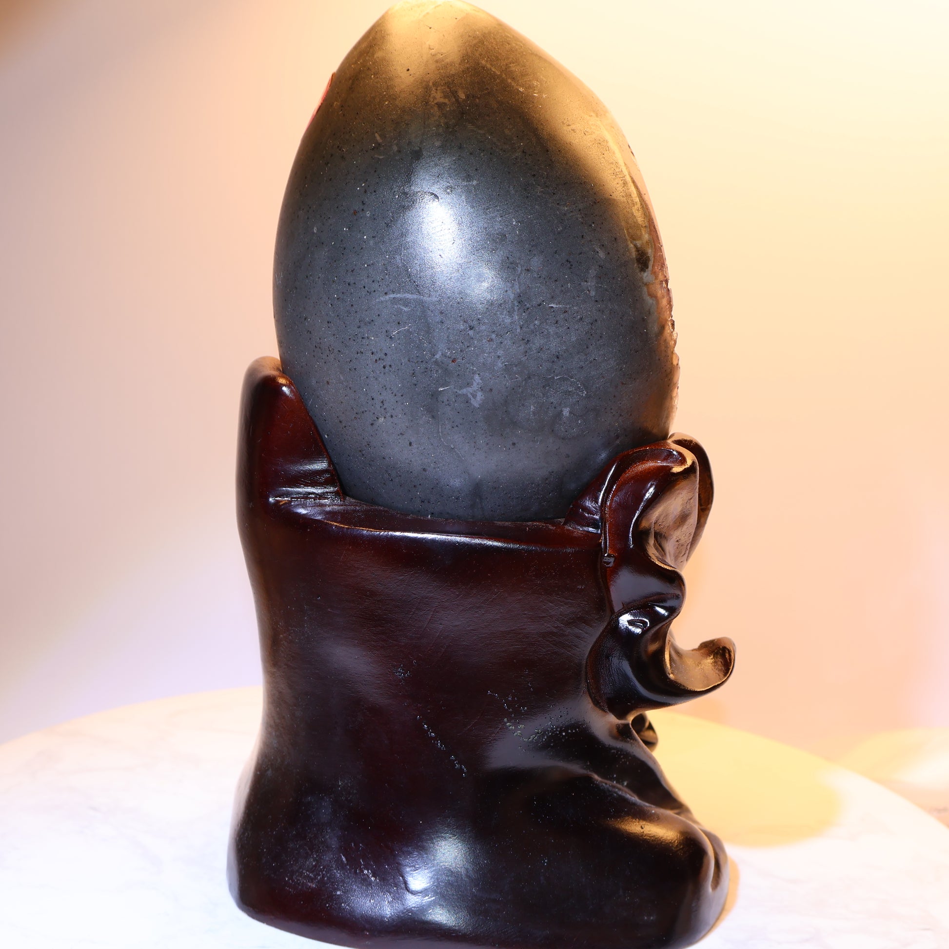 Angled view of wooden lotus carving and geode placement