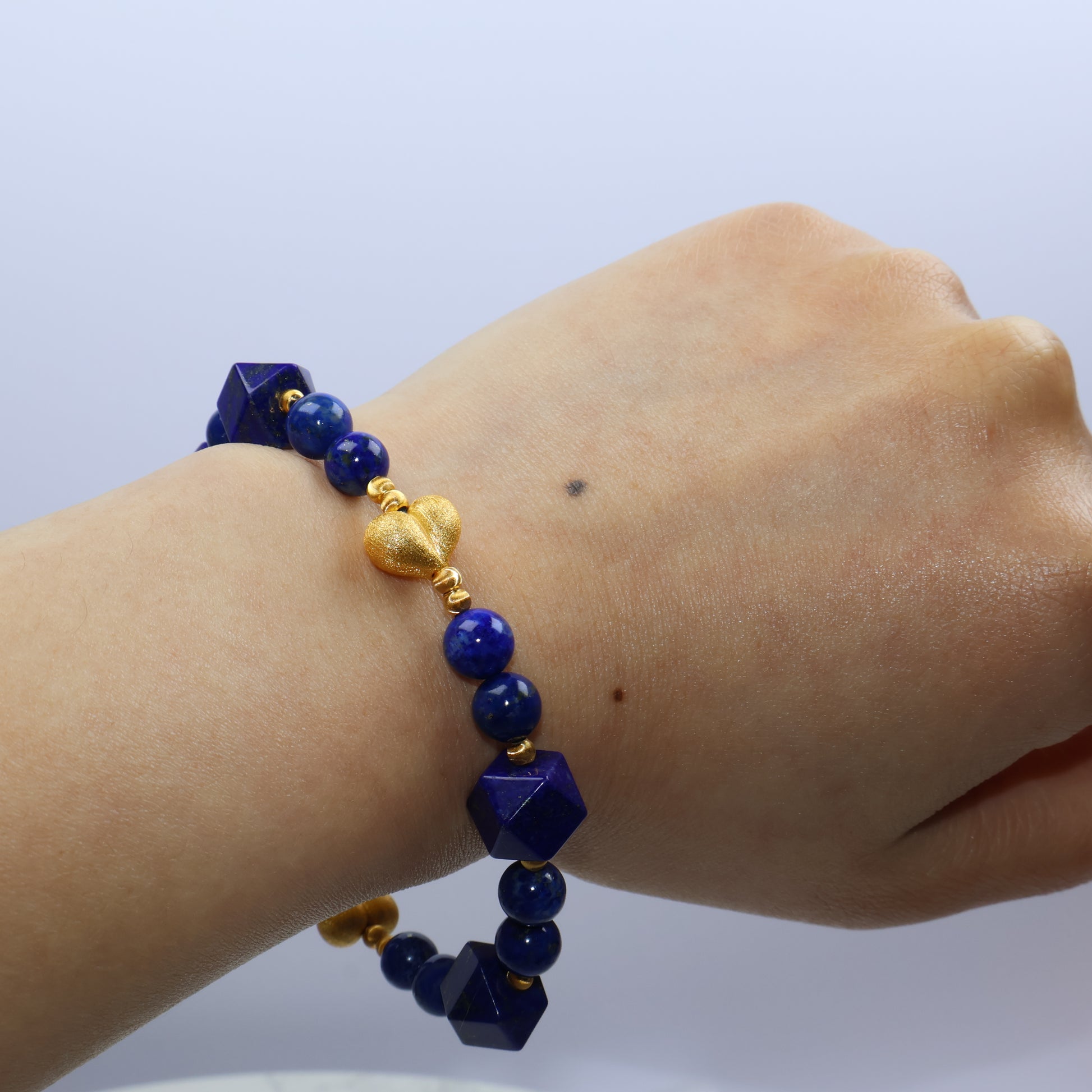 Angle shot showing bold pentagon-shaped lapis beads paired with round accents