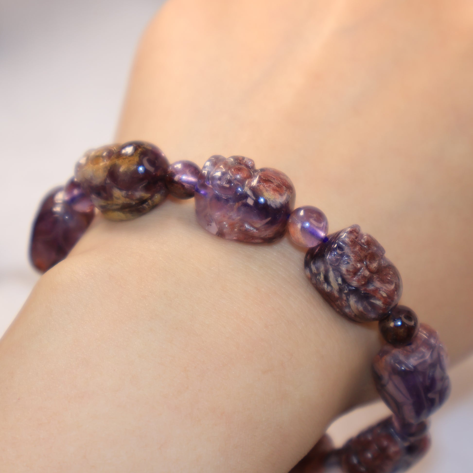 Elegant Purple Phantom Quartz Pixiu bracelet worn on wrist with polished crystal finish