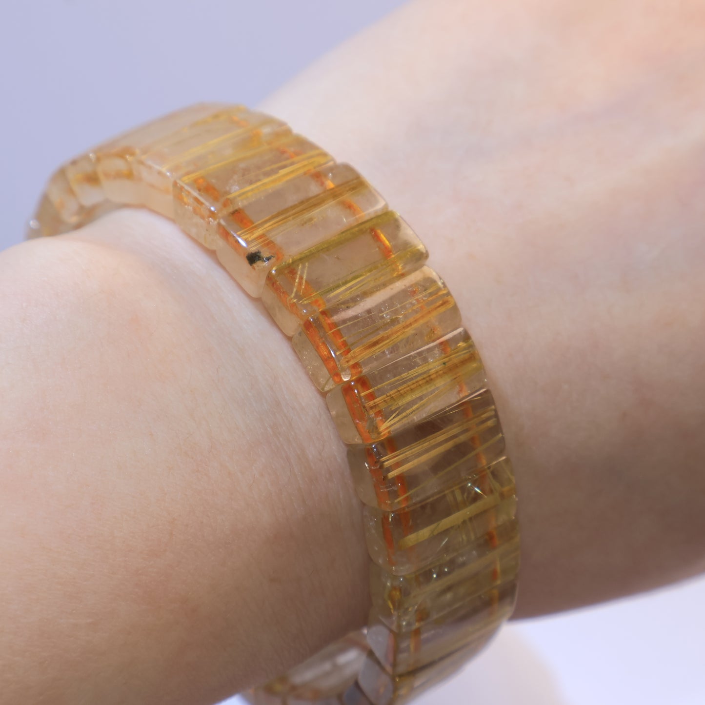 Golden Rutilated Quartz bracelet worn on wrist, showing its rectangular design.