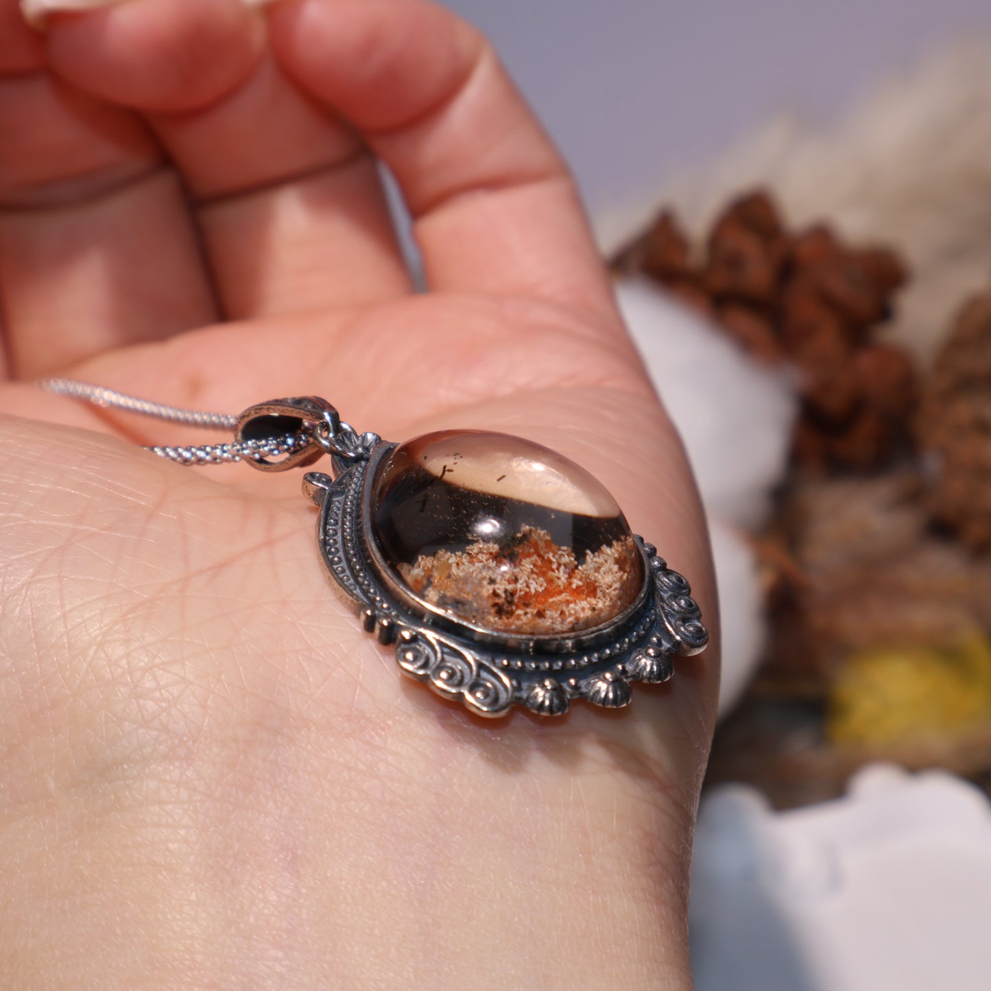 Side view of domed crystal revealing depth and silver frame details.