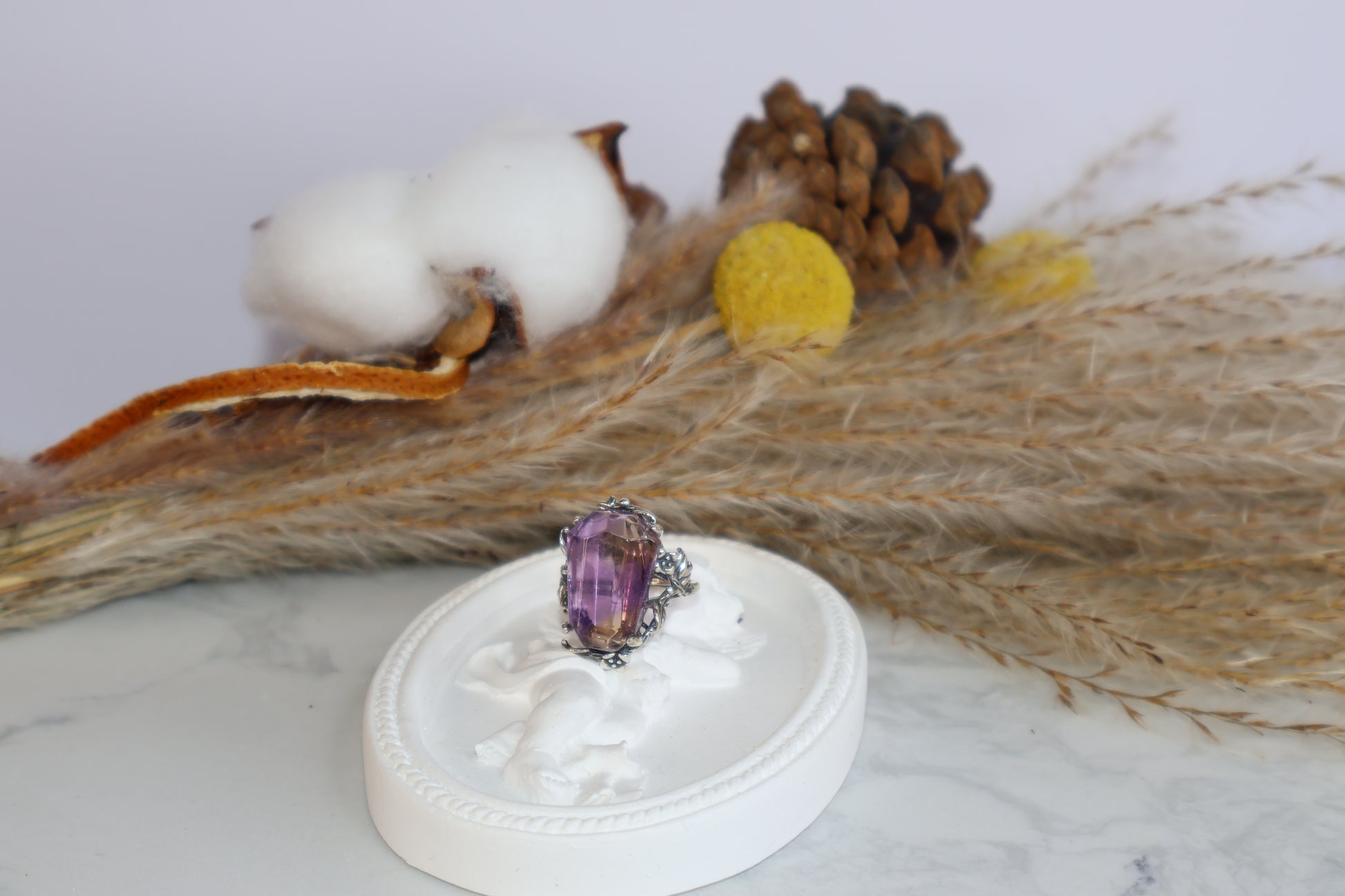 Close-up of freeform faceted Ametrine crystal in oxidized silver botanical setting