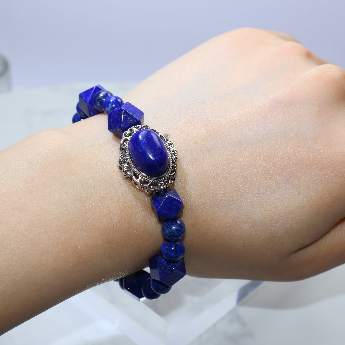 Artistic hand pose displaying the elegance and dimension of deep blue Lapis Lazuli bracelet