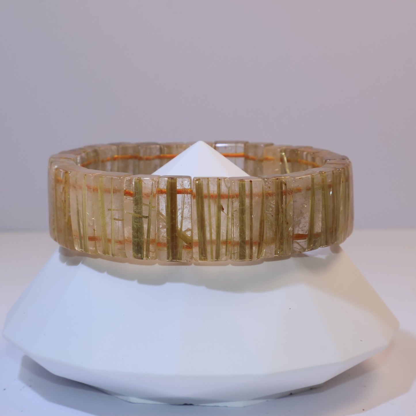 Side view of the Golden Rutilated Quartz bracelet on display stand.