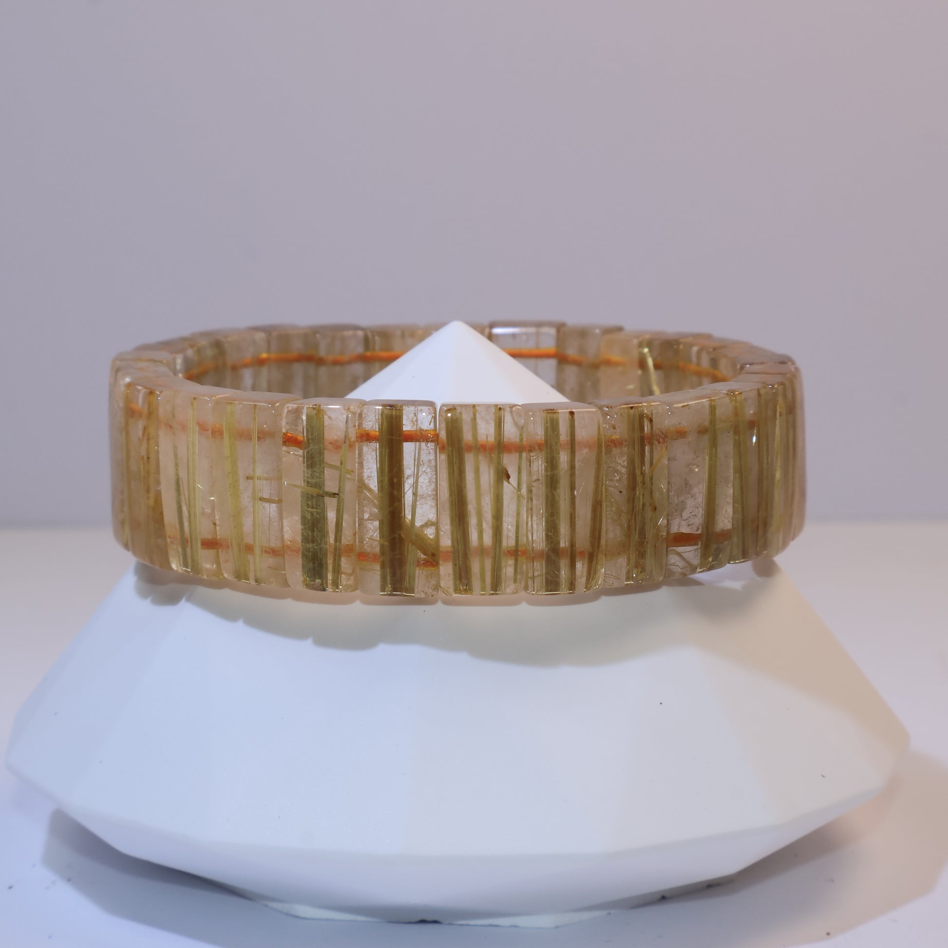 Side view of the Golden Rutilated Quartz bracelet on display stand.