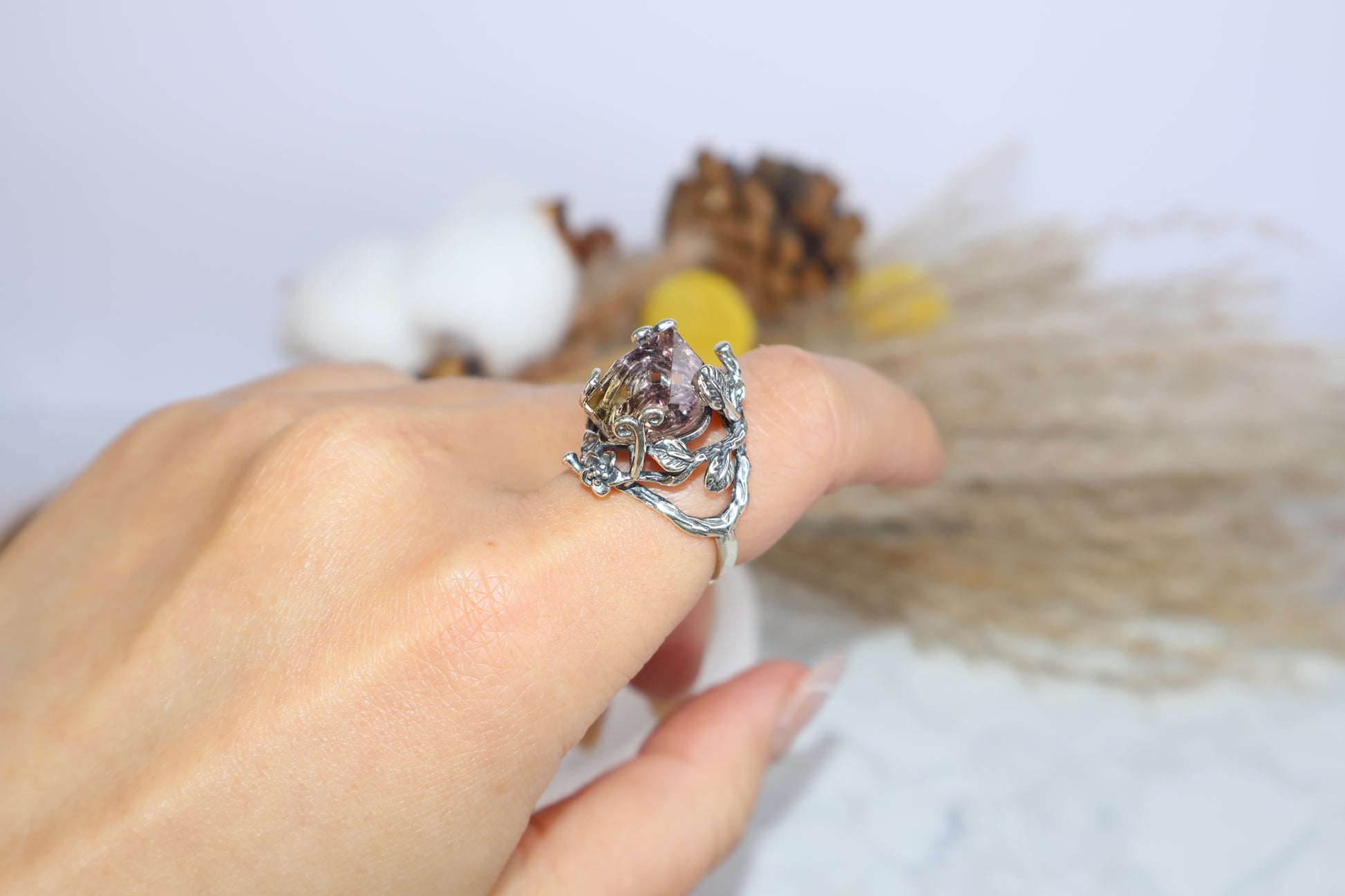 Side view of the floral ametrine ring worn on hand