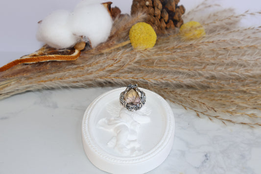 Ametrine crystal ring with vintage silver floral design on angel dish display