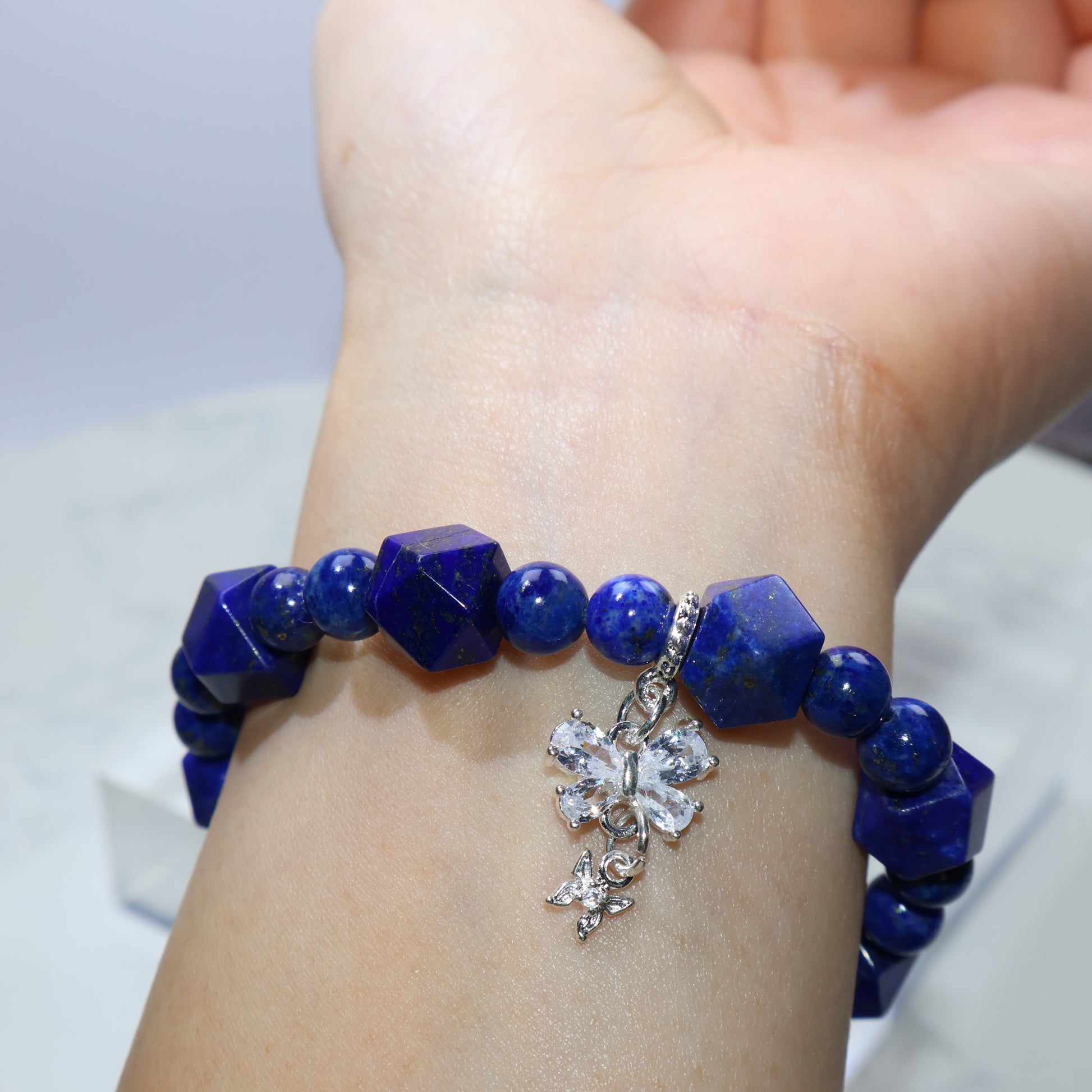 Styled shot of bracelet worn on wrist with gemstone centerpiece facing up
