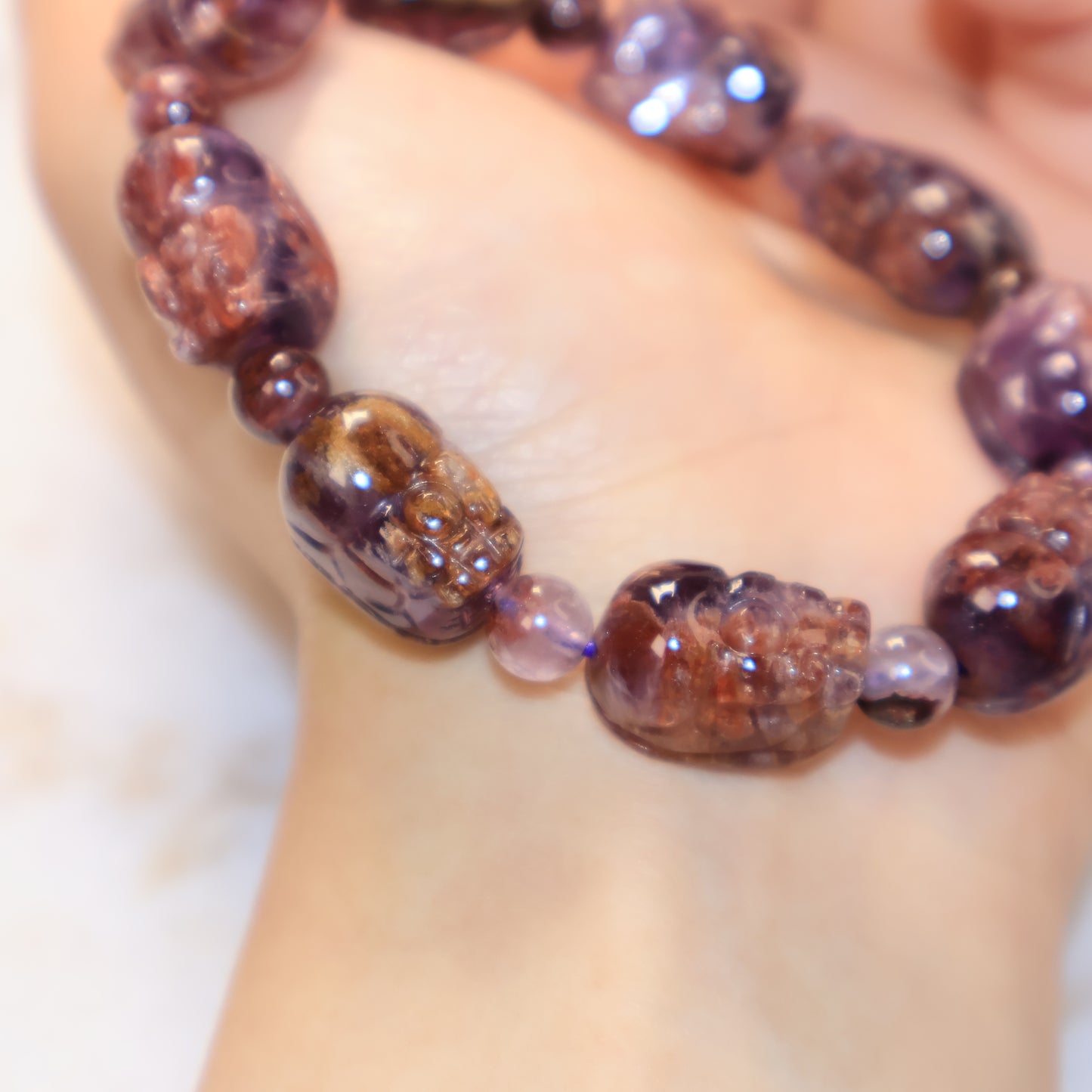 Detailed wrist shot of Purple Phantom Quartz Pixiu bracelet with mystical purple hues