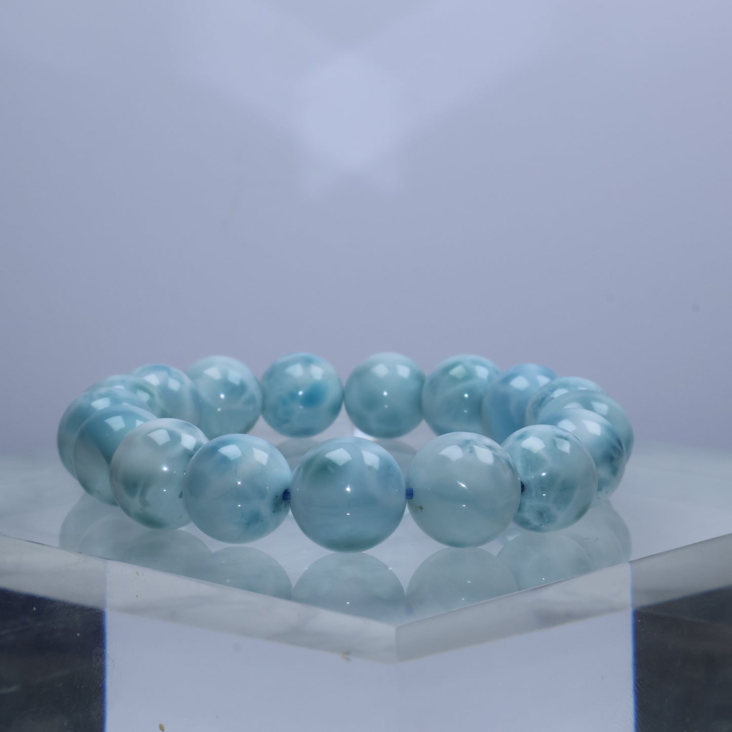 Side angle of pale blue Larimar bracelet against soft gradient background