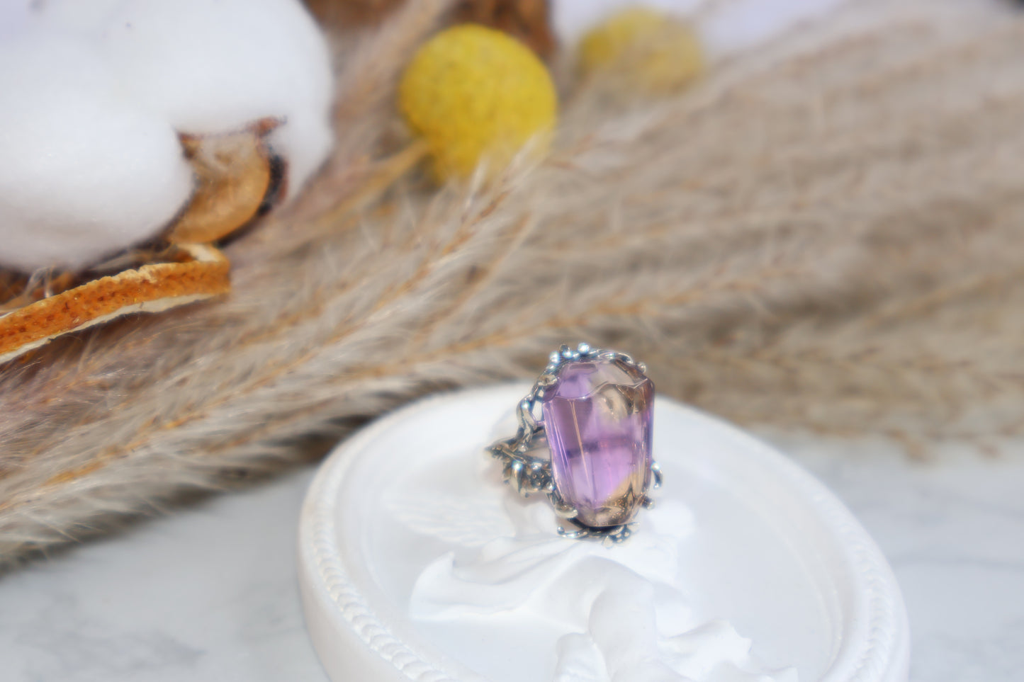 Flat lay of statement Ametrine ring with nature-inspired floral design