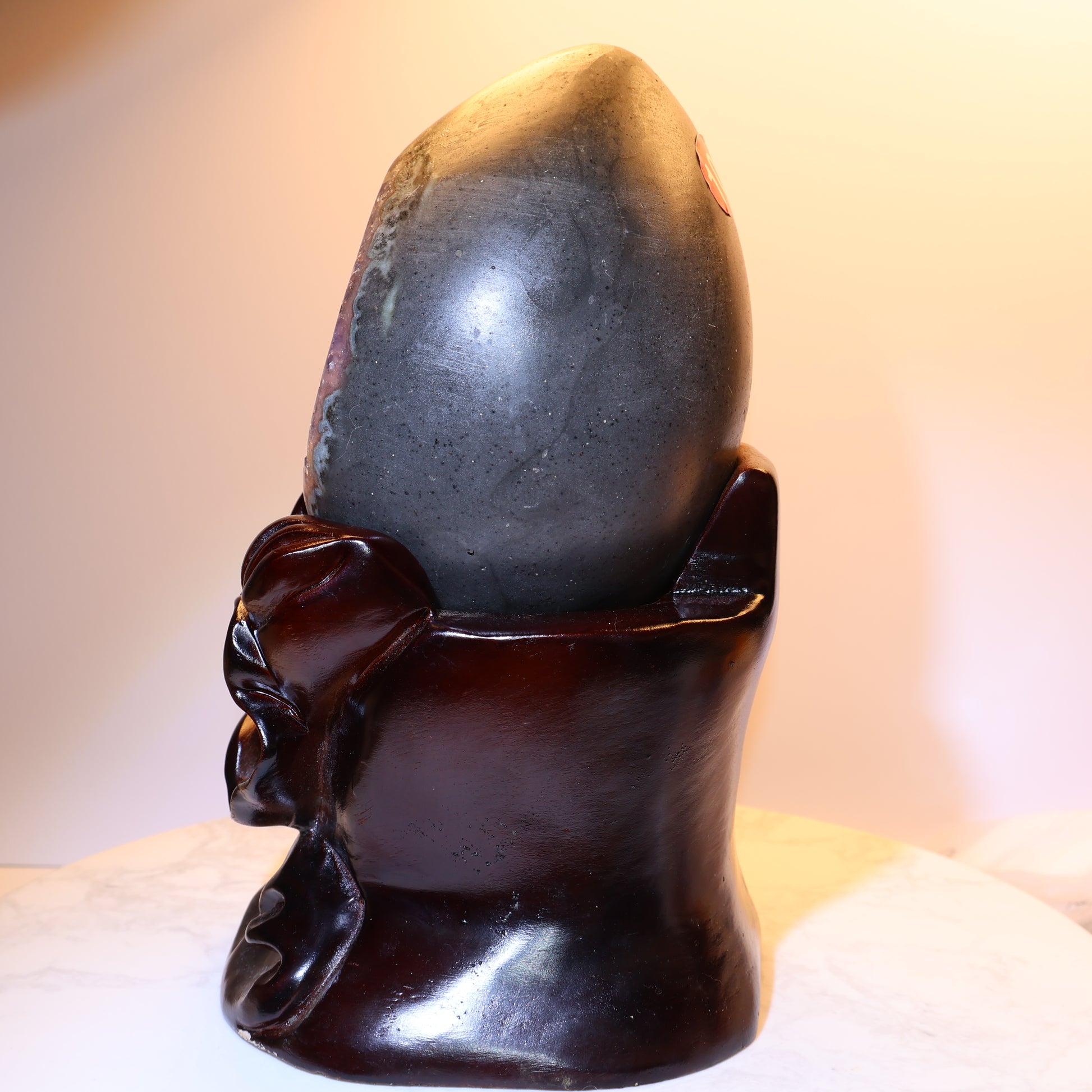 Side profile showing smooth outer shell of amethyst geode