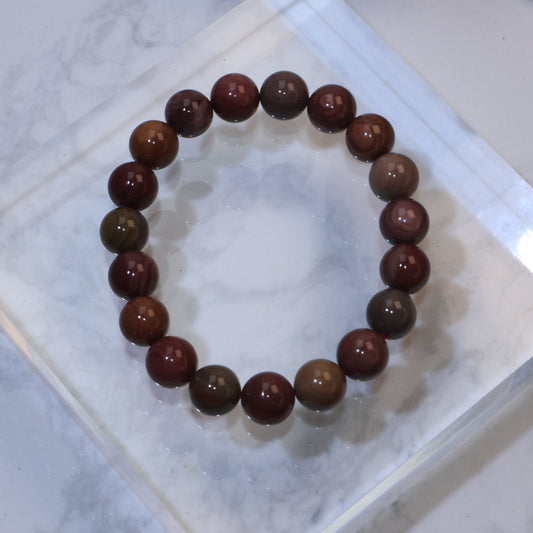 Top-down view of 10mm Mookaite Jasper bracelet showing natural earthy tones and patterns