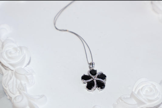 Black spinel and CZ flower pendant on white background – 16mm S925 jewelry piece
