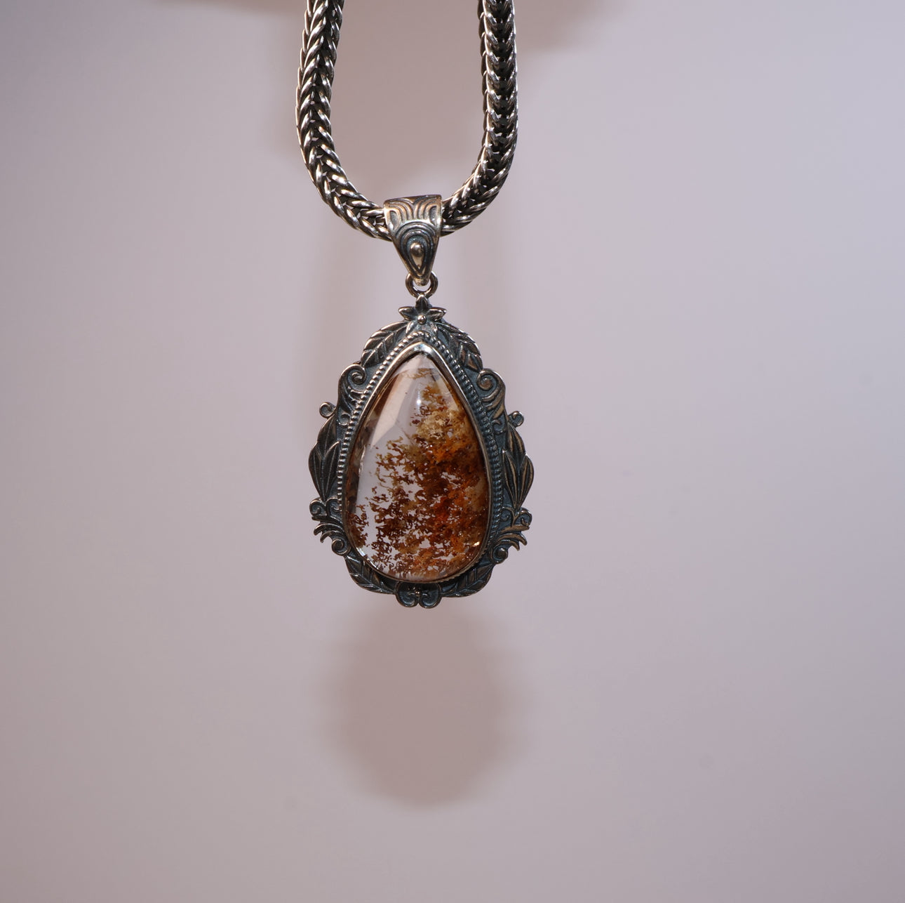 Hanging Phantom Quartz pendant, floating effect with visible silver detailing