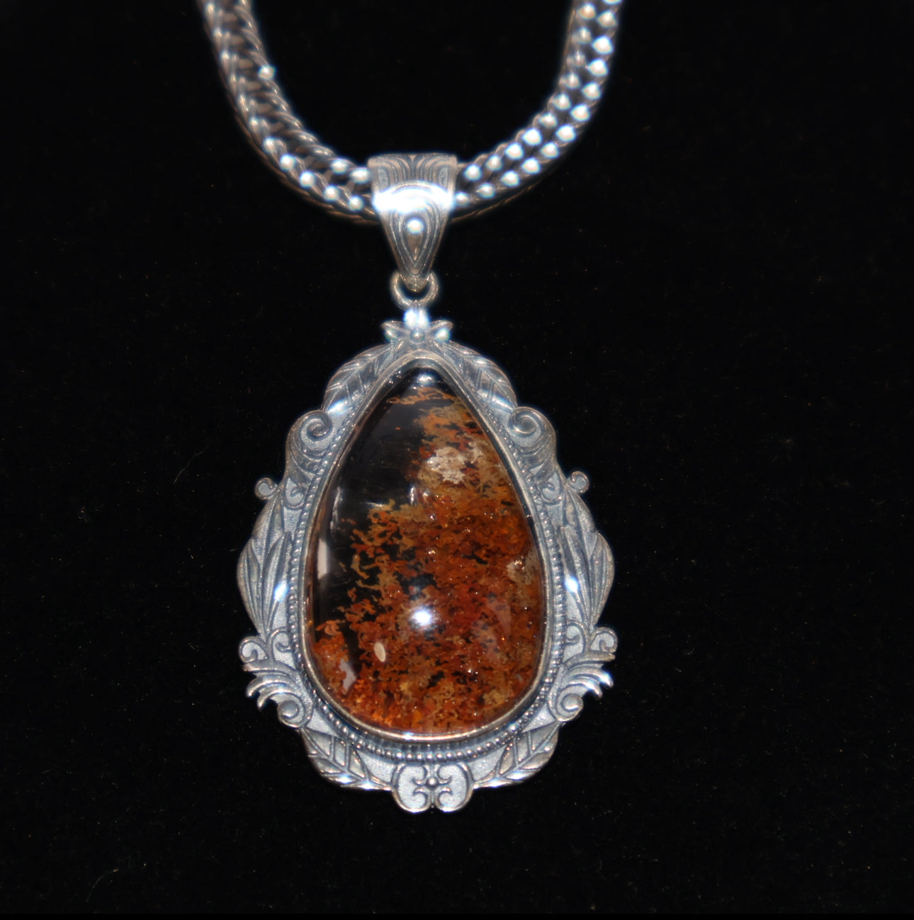 Pendant shown on dark background to highlight rich phantom details