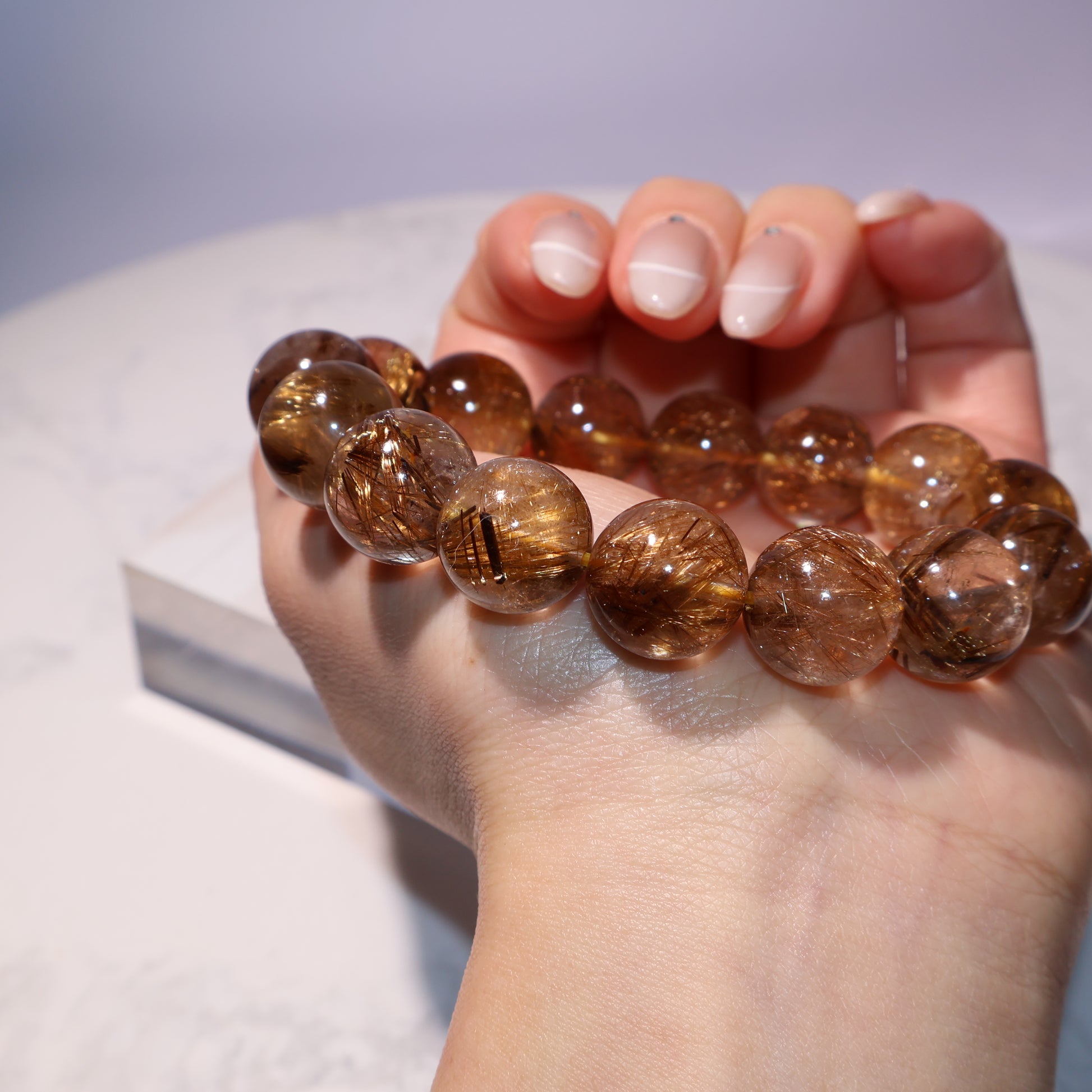 Elegant wrist shot showing the size and glow of golden brown rutile beads