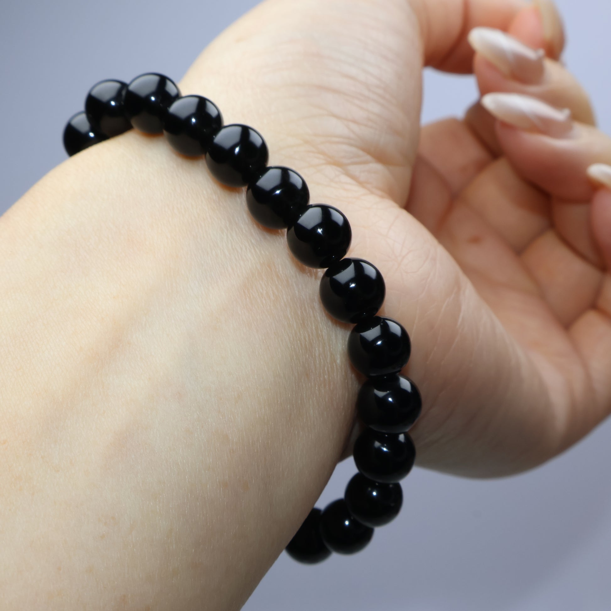 Side view of bracelet against wrist showing alignment and polish of beads