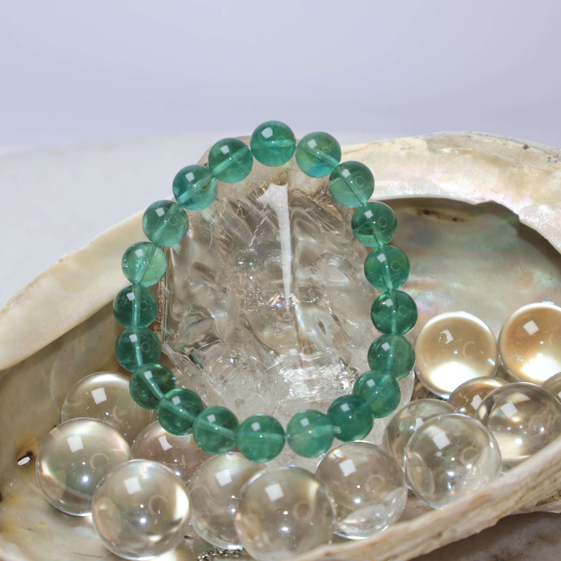 Natural 9mm Green Fluorite Bracelet Displayed in Seashell