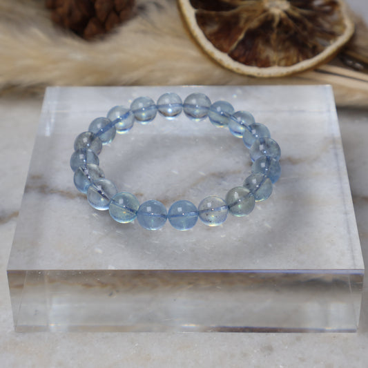 Natural 9mm Aquamarine crystal bracelet on acrylic display stand