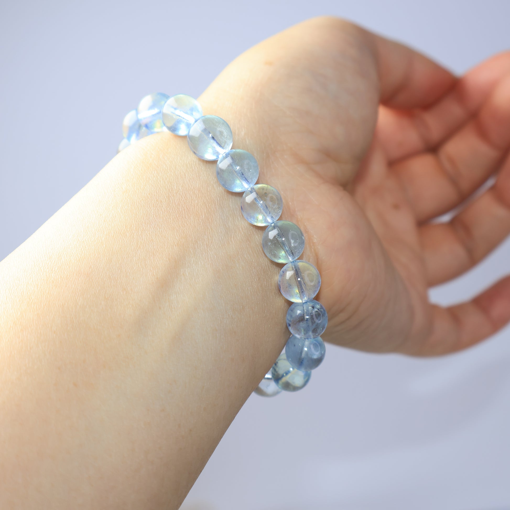Genuine 9mm Aquamarine crystal bracelet worn on wrist side view