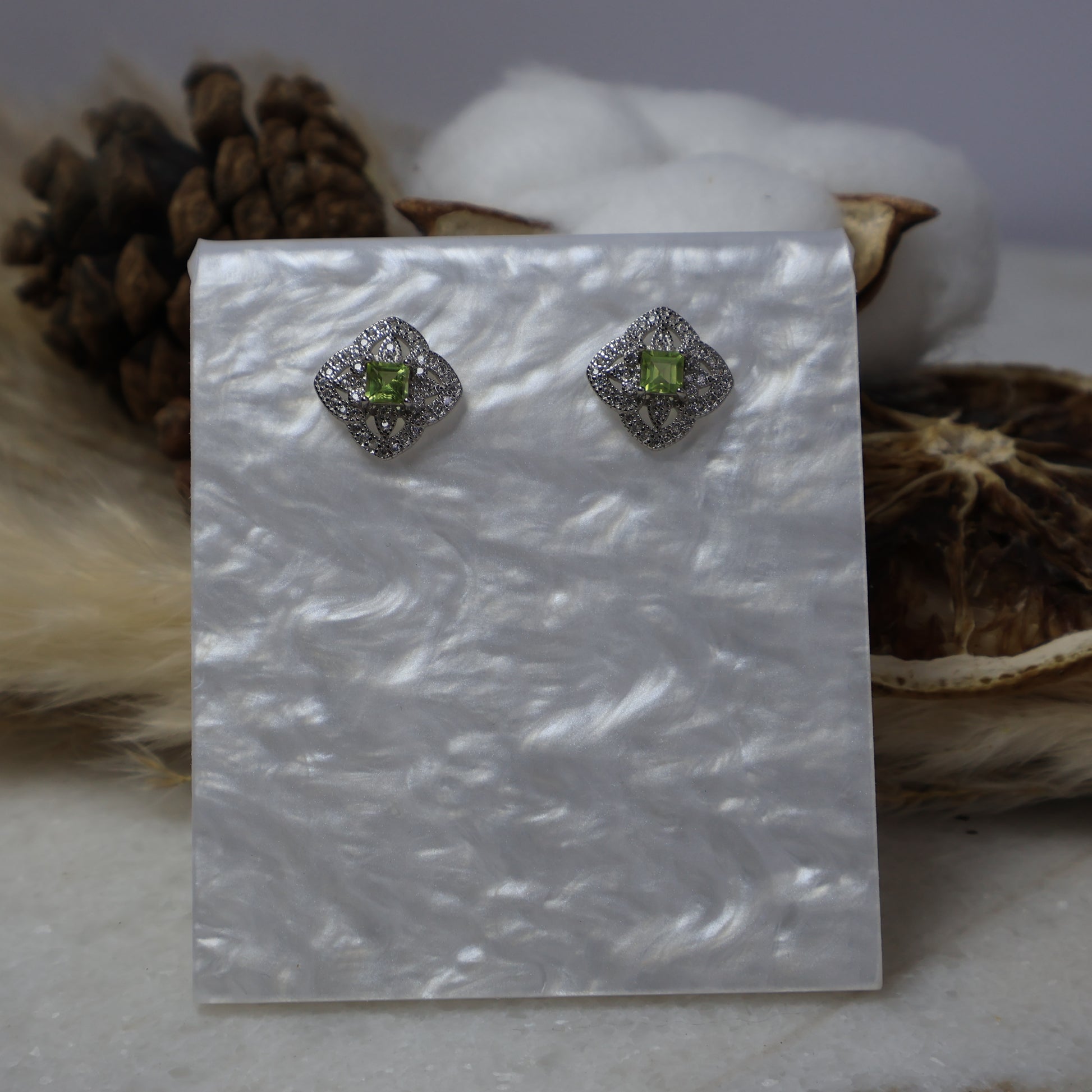 S925 sterling silver peridot stud earrings with cubic zirconia on display